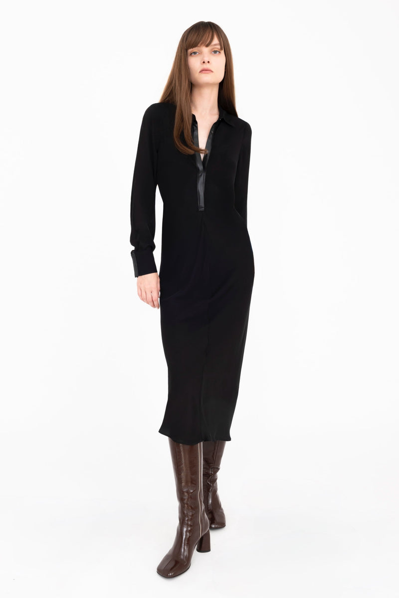 Woman wearing a black dress and boots on a white background