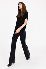 Person wearing a black outfit on a white background