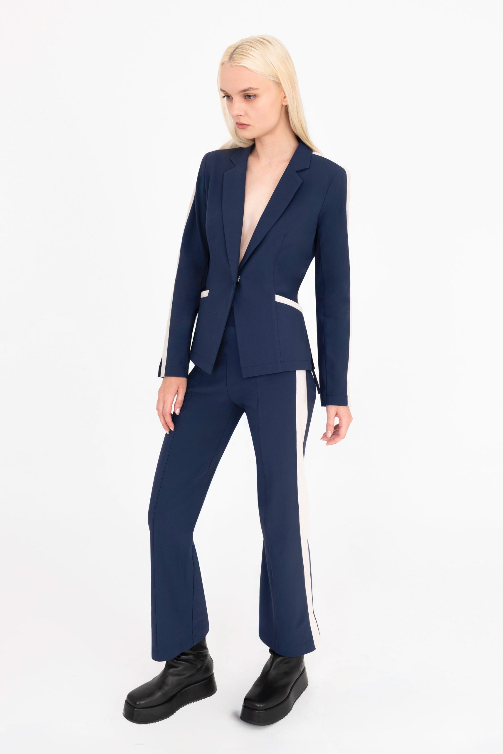 Woman wearing a navy blue suit with a white background