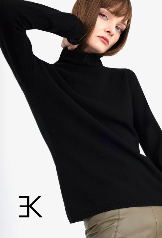 Person wearing a black turtleneck with a elaine kim logo on a white background