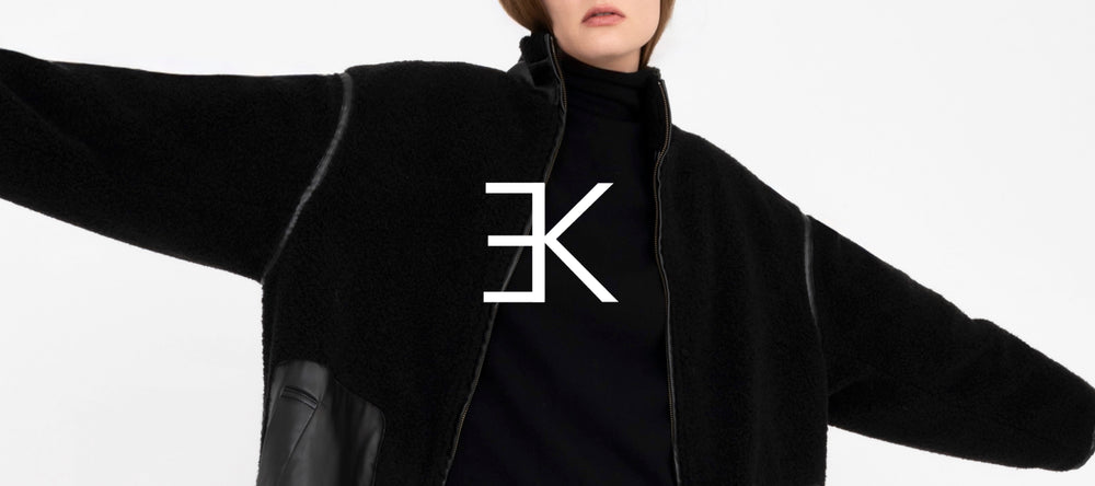 Person wearing a black coat with a brand logo on a white background