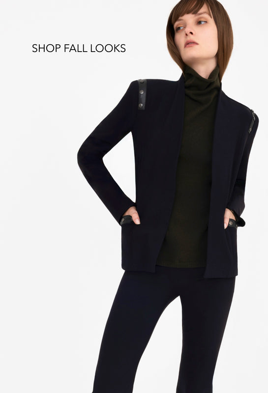Woman wearing a black outfit with a blazer on a white background