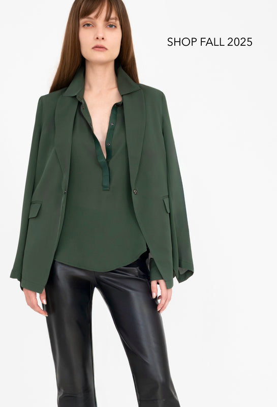Woman wearing a green blazer over a shirt with leather pants on a white background, with text 'Shop Fall 2025'.