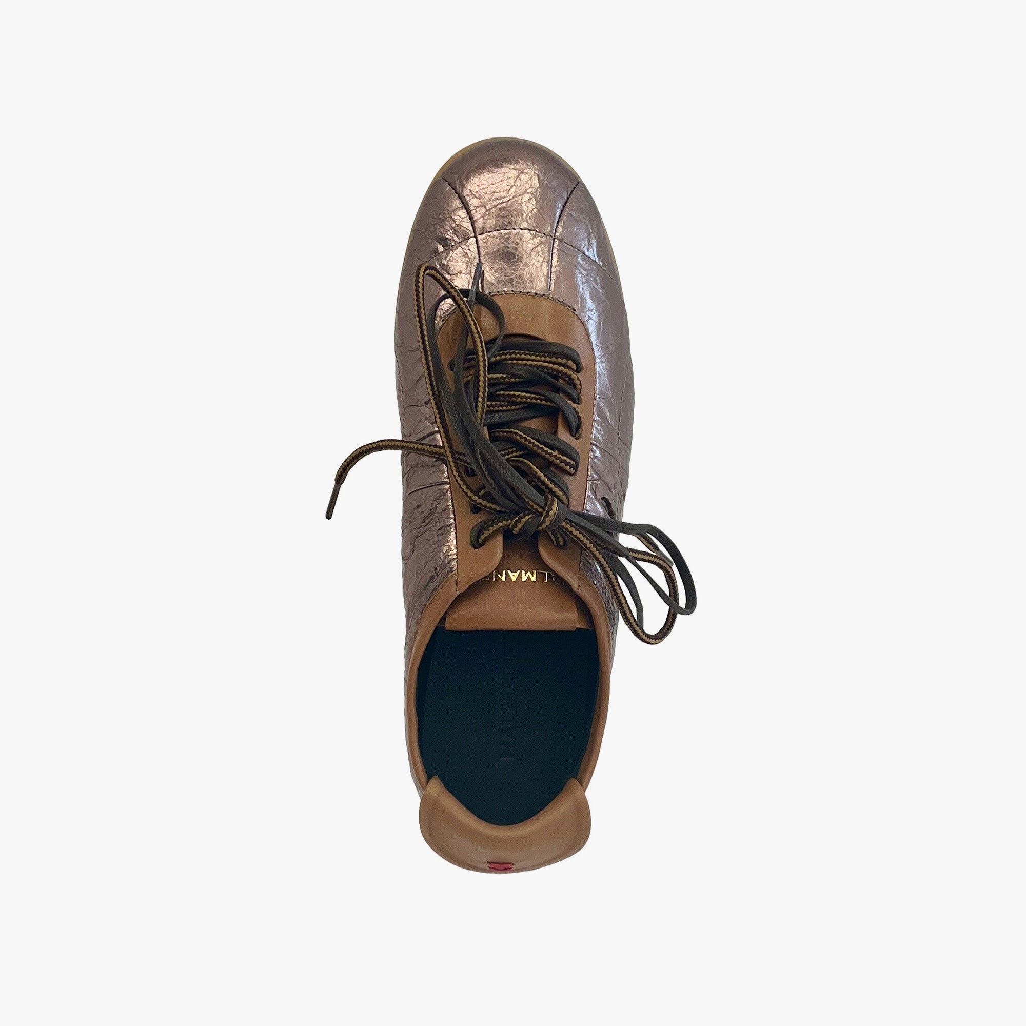 A single metallic bronze leather sneaker shown from a top-down view against a light gray background. The shoe features a textured metallic finish, dark brown laces, and a tan collar.