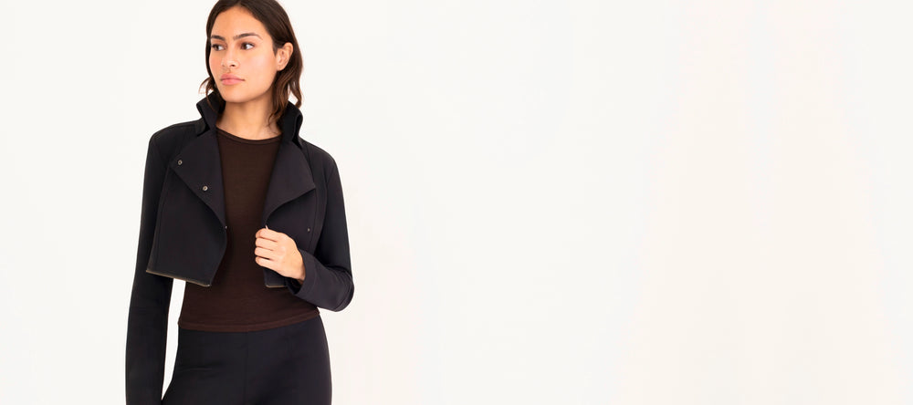 Woman wearing a black jacket on a white background