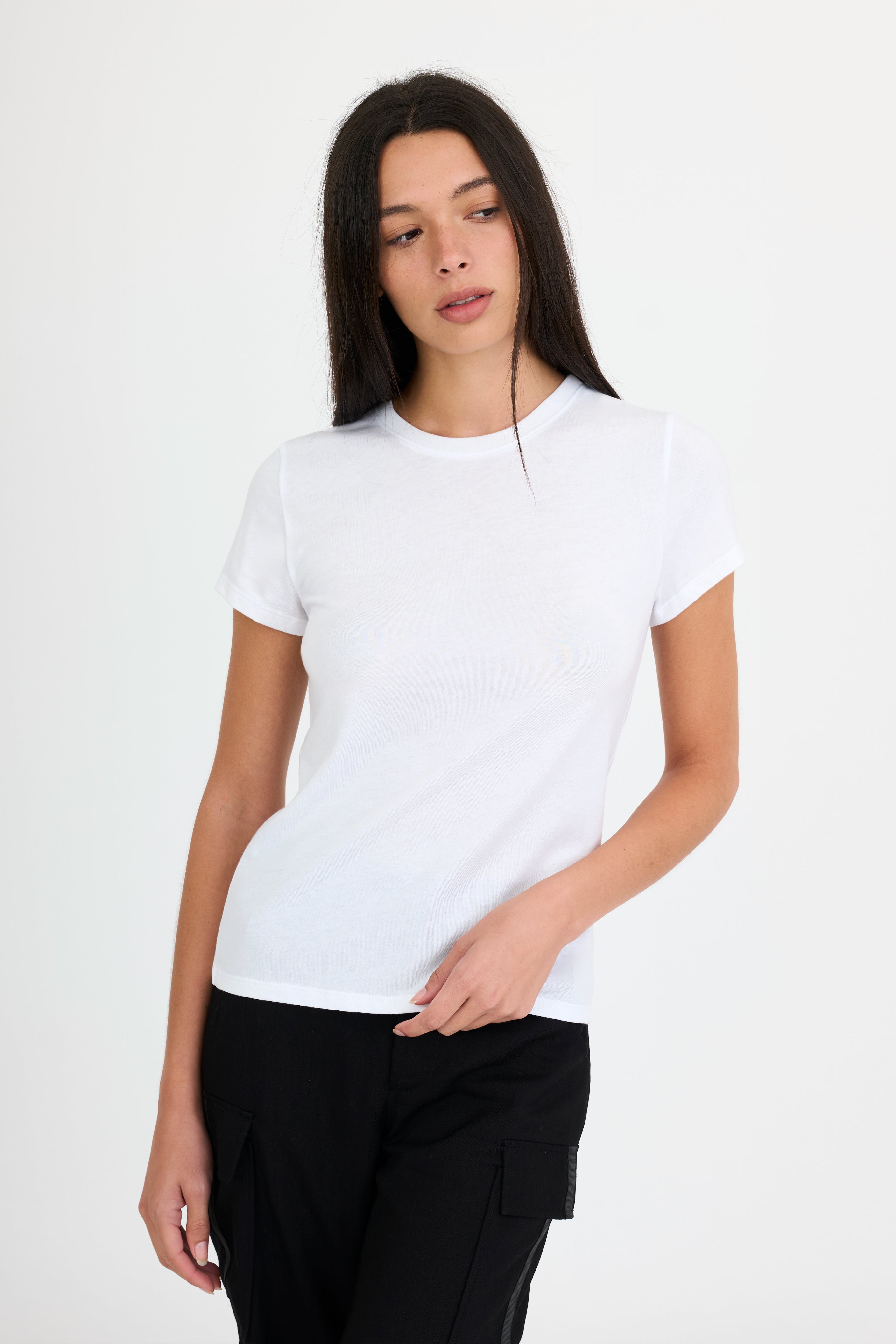 Woman wearing a white t-shirt and black pants on a white background
