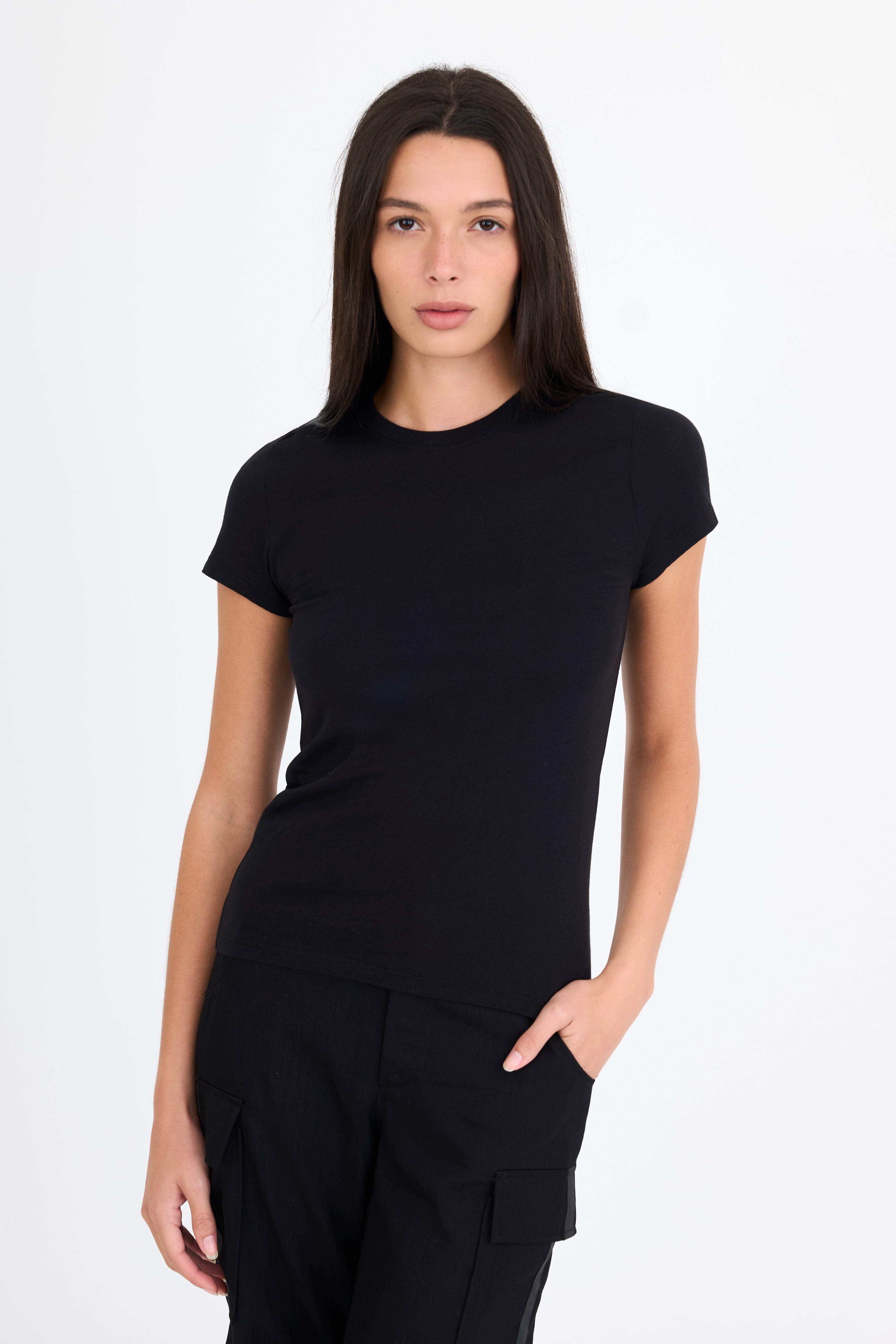Woman wearing a black t-shirt and black pants on a white background