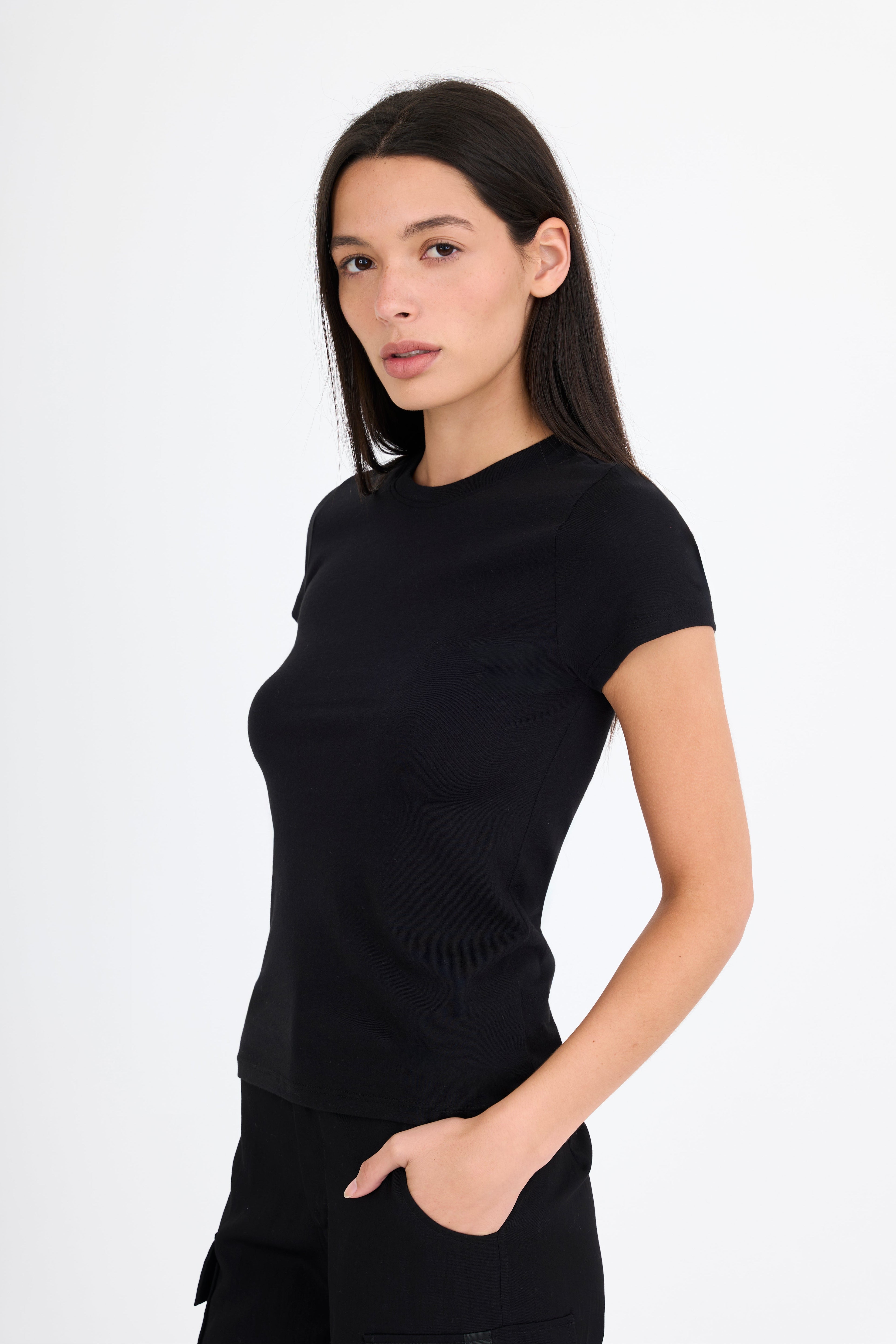 Woman wearing a black t-shirt and black pants on a white background