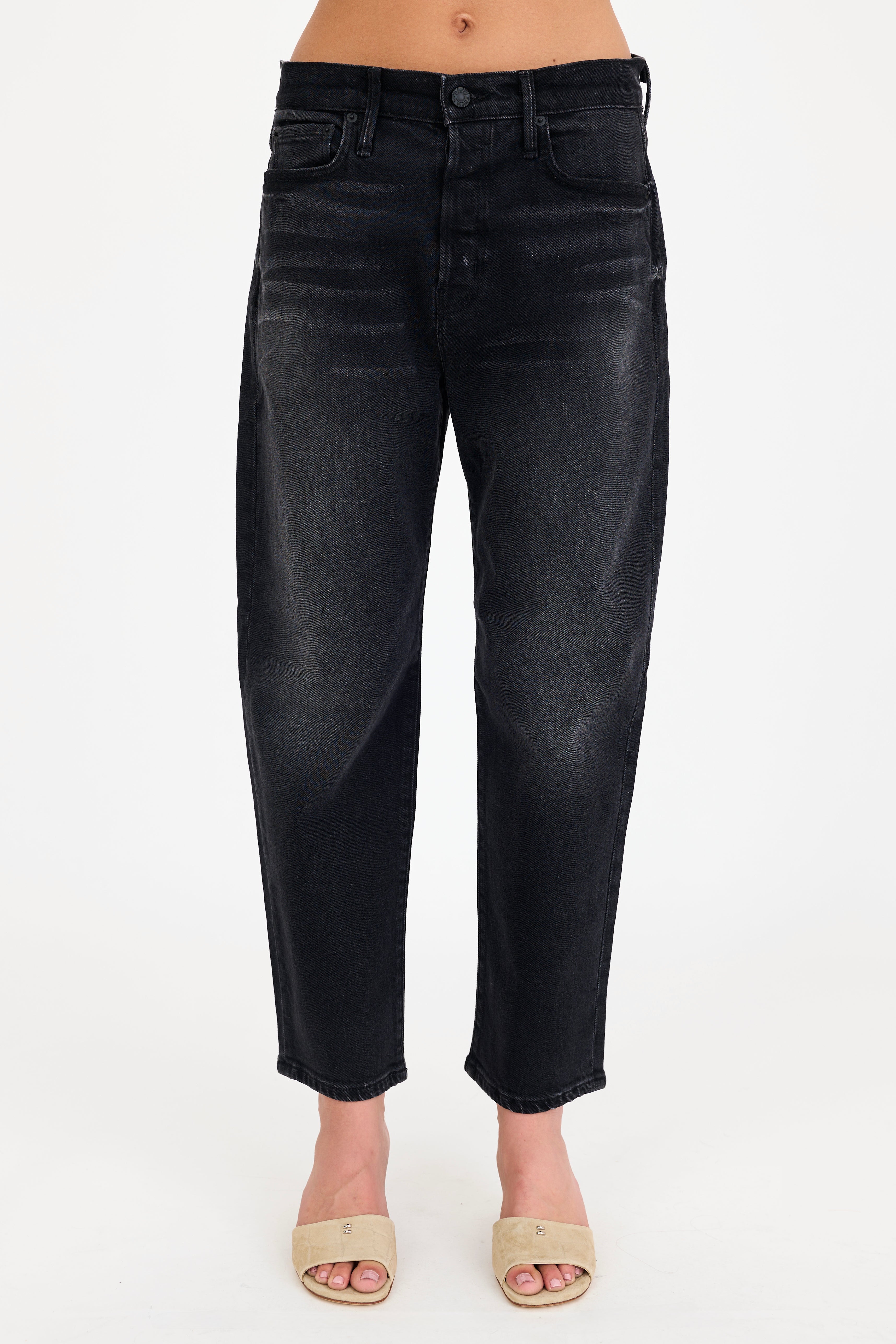 Black jeans worn by a person on a white background
