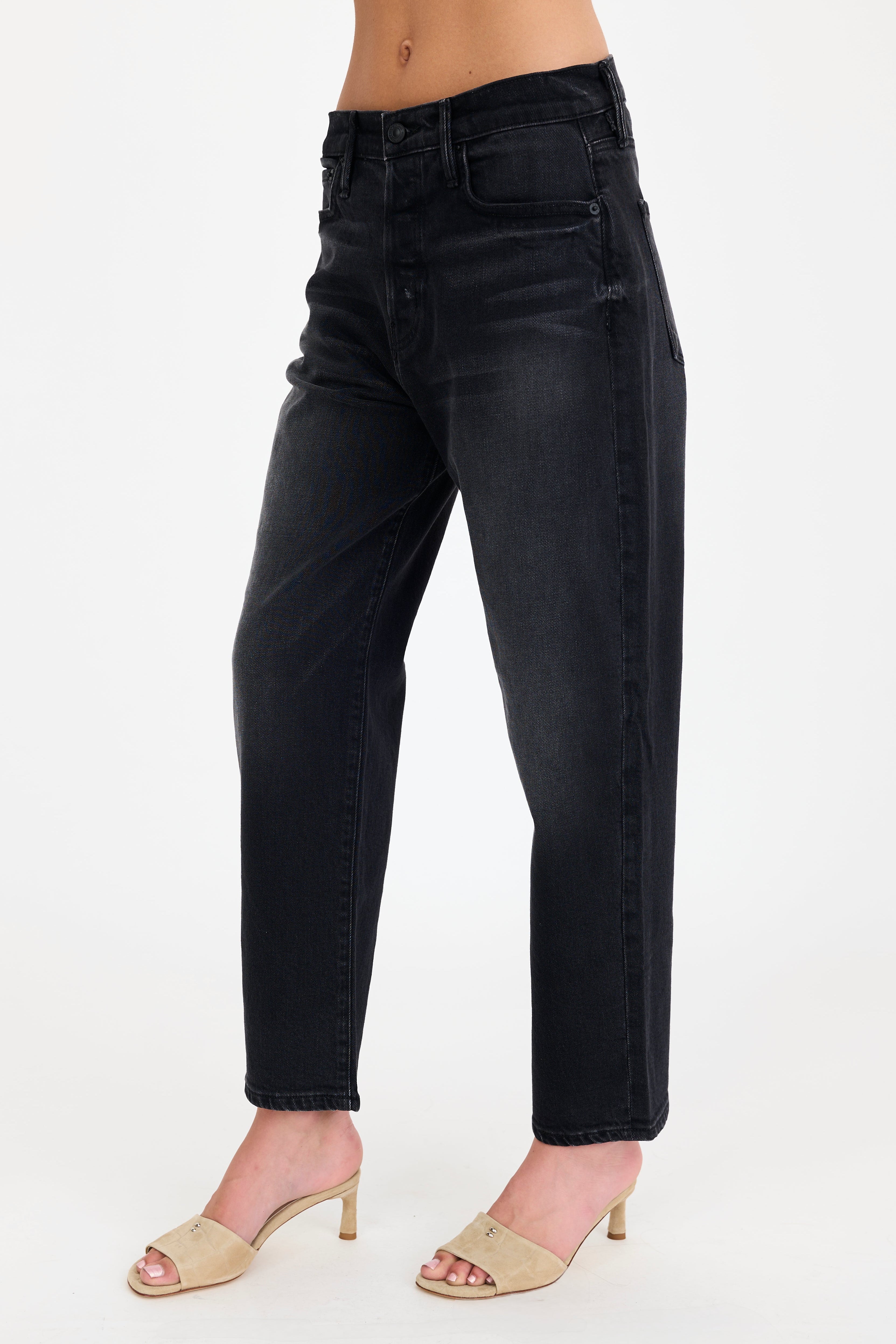 Black jeans worn by a person on a white background
