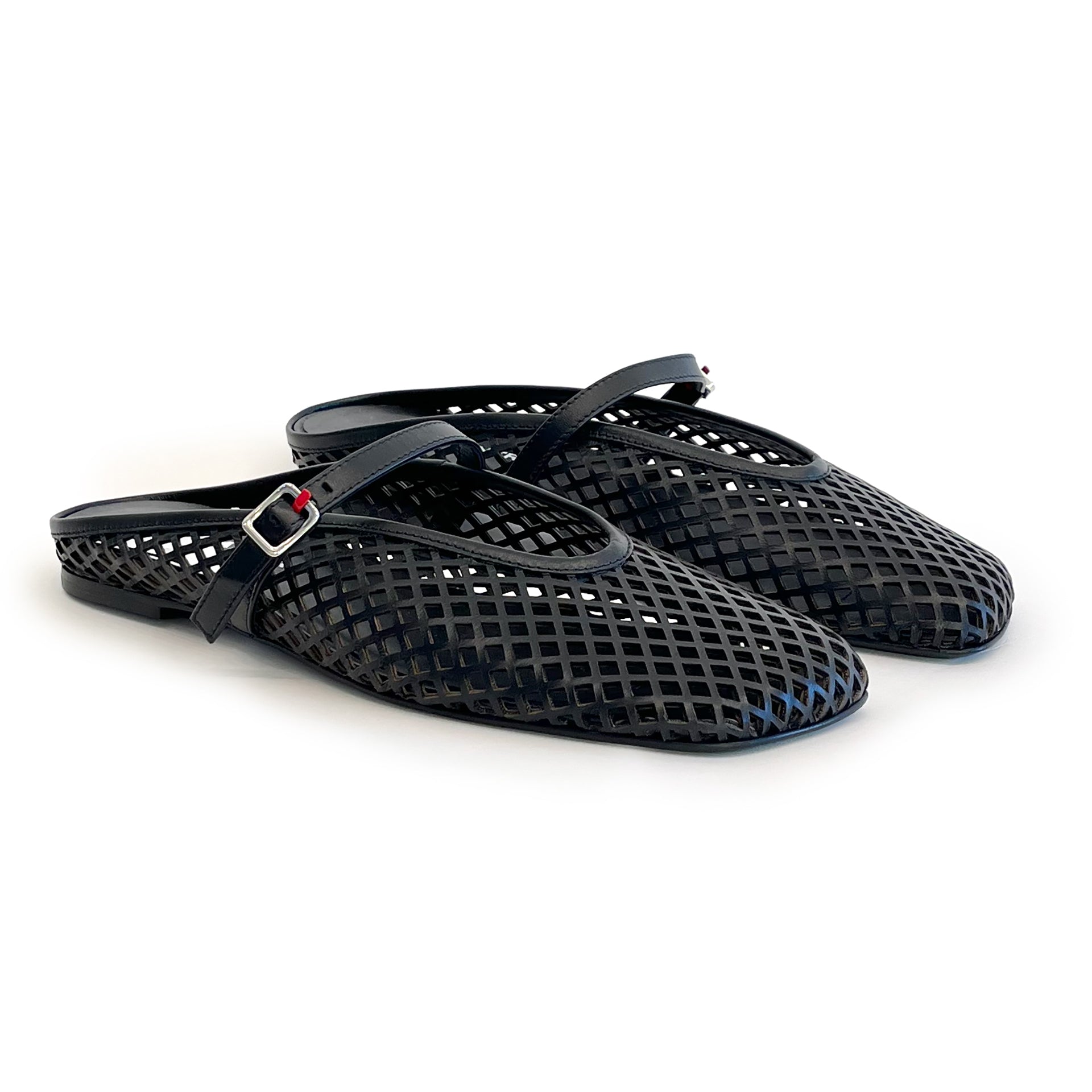Black laser cut leather strap slip on flat shoes on a white background