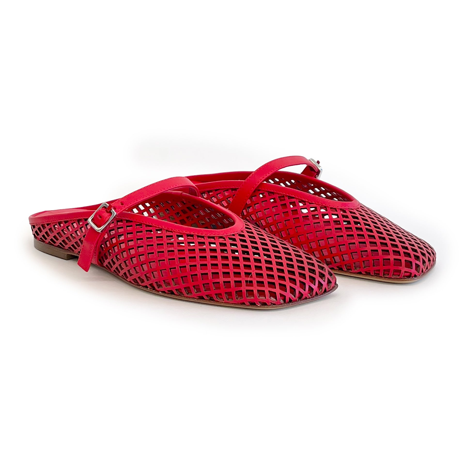 Red laser cut leather strap slip on flat shoes on a white background