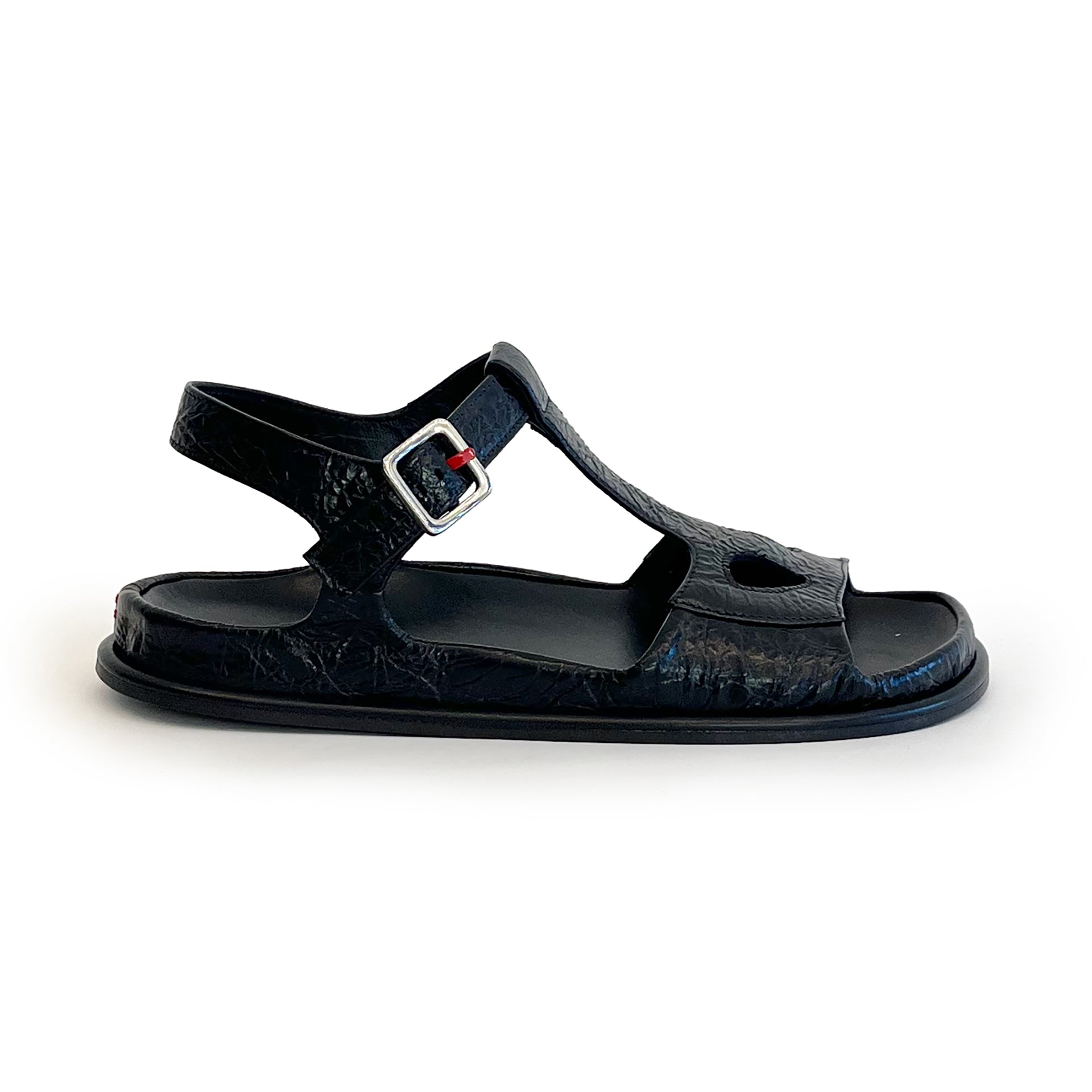 Black ankle strap flat sandal on a white background