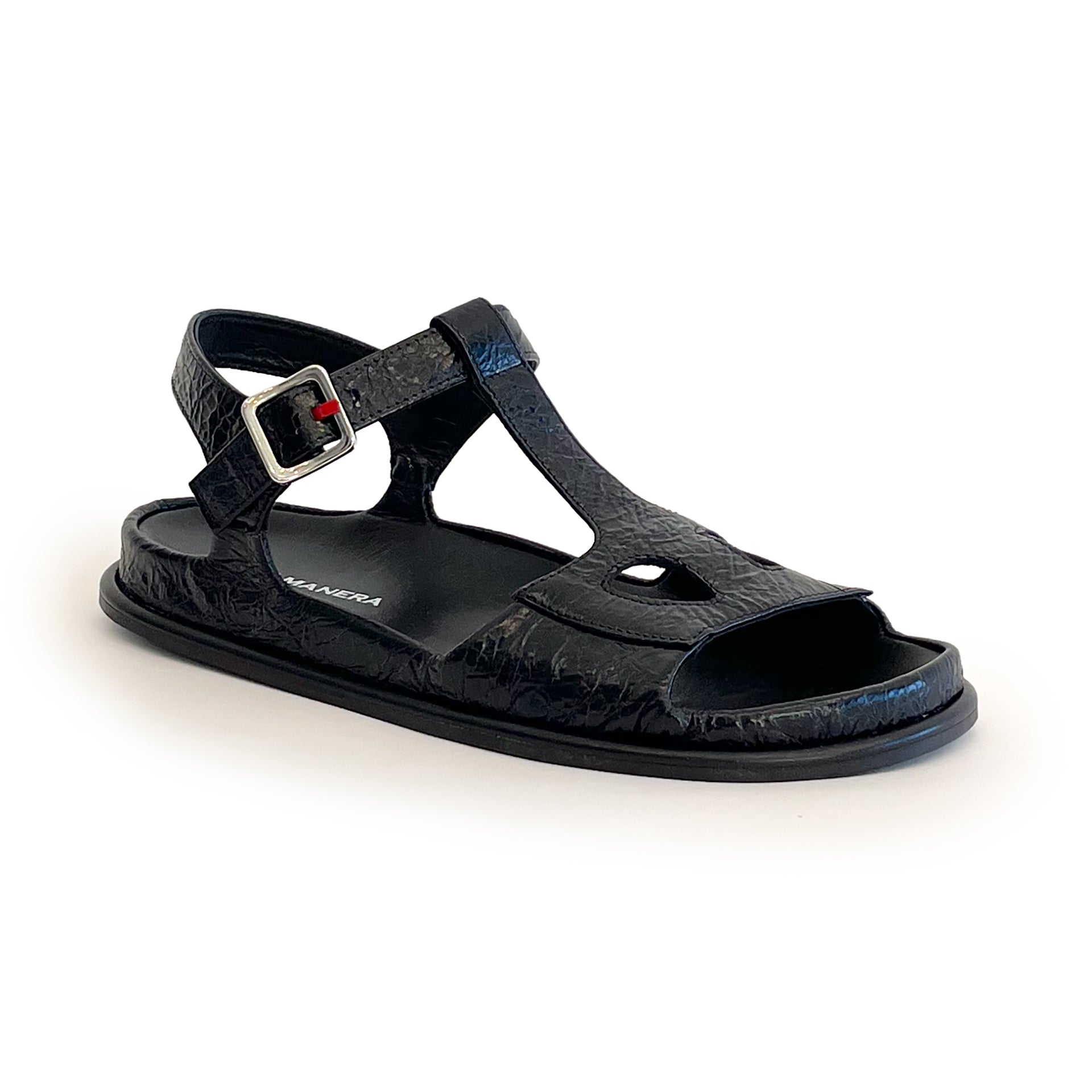 Black ankle strap flat sandal on a white background