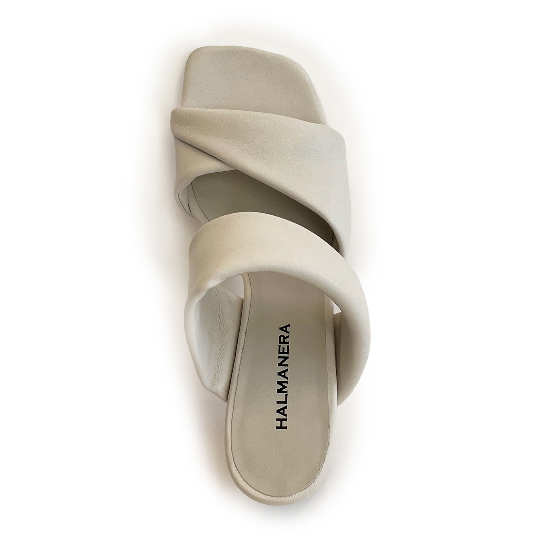 Ivory sculptured chunky heel sandal on a white background