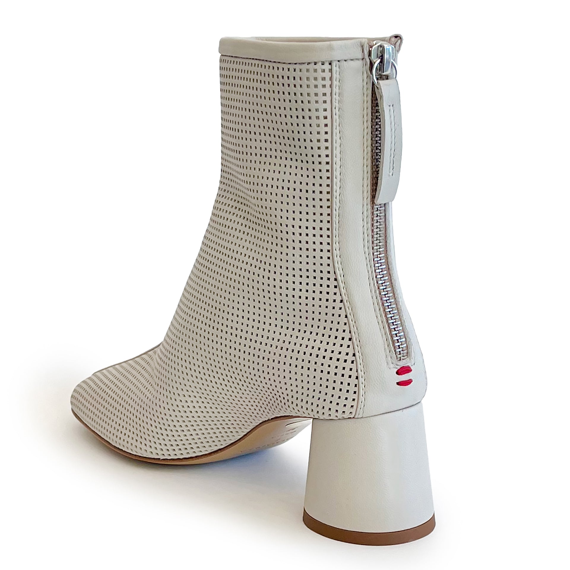 Beige round toe perforated ankle boot on a white background