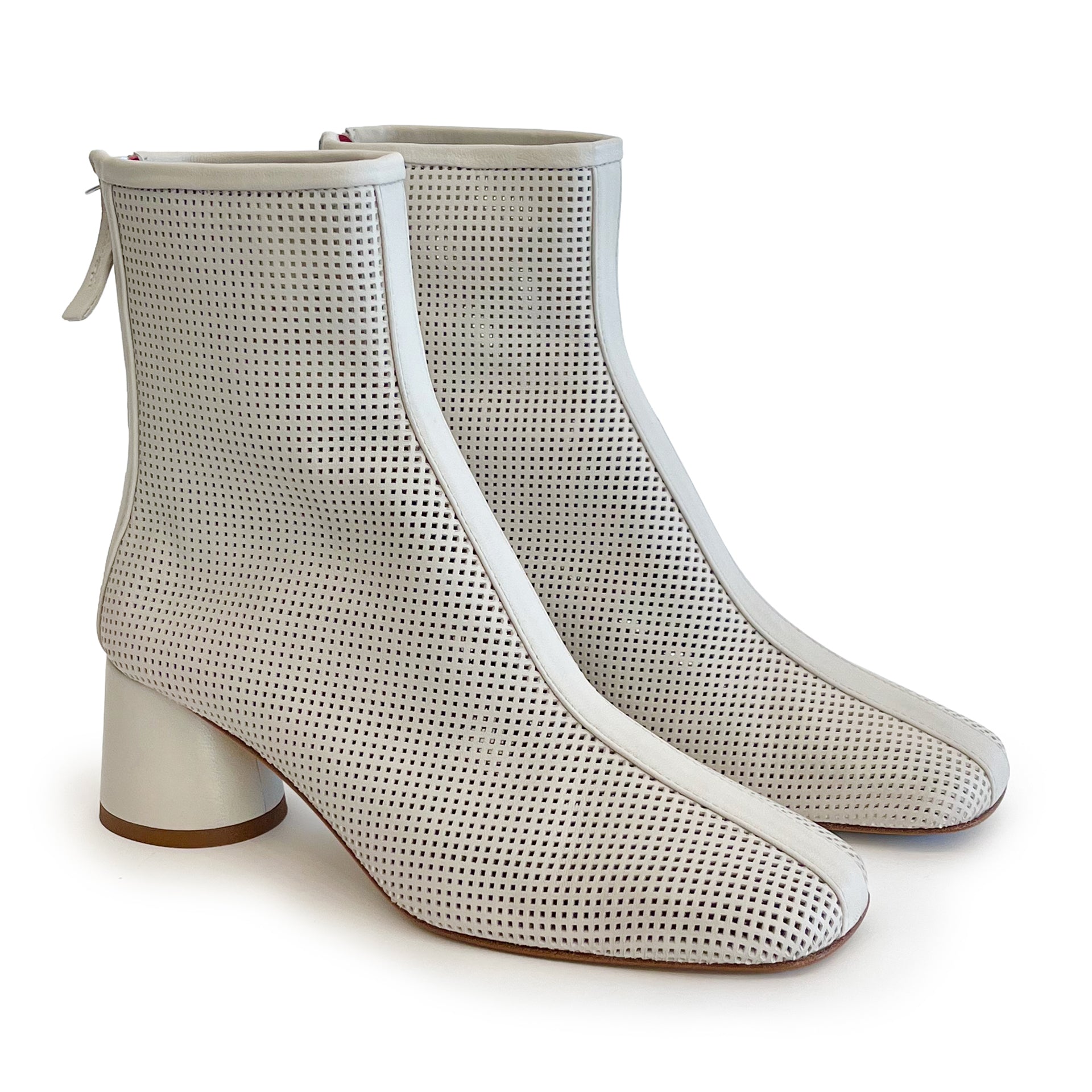 Beige round toe perforated ankle boot on a white background