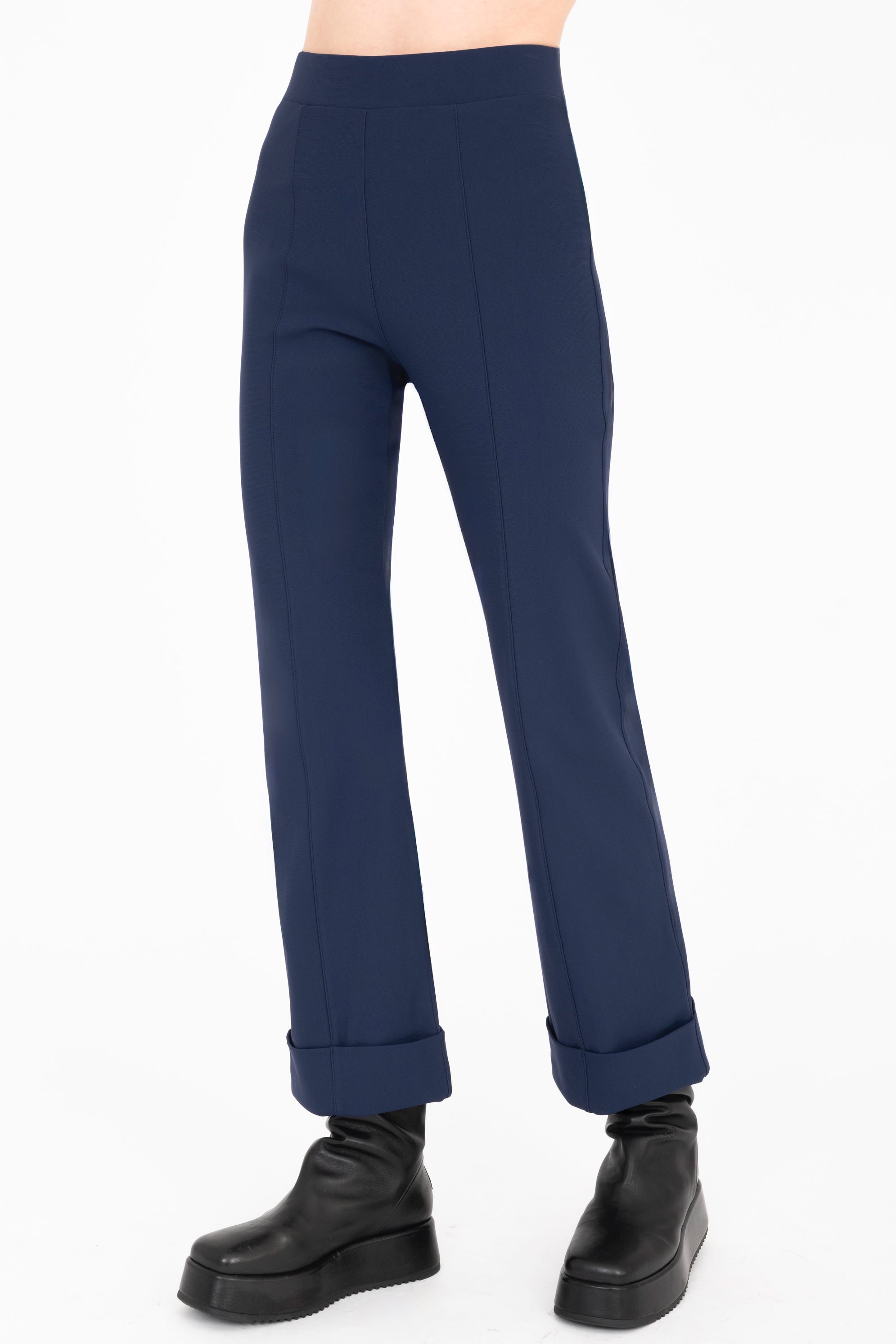 Navy blue pants worn by a person on a white background