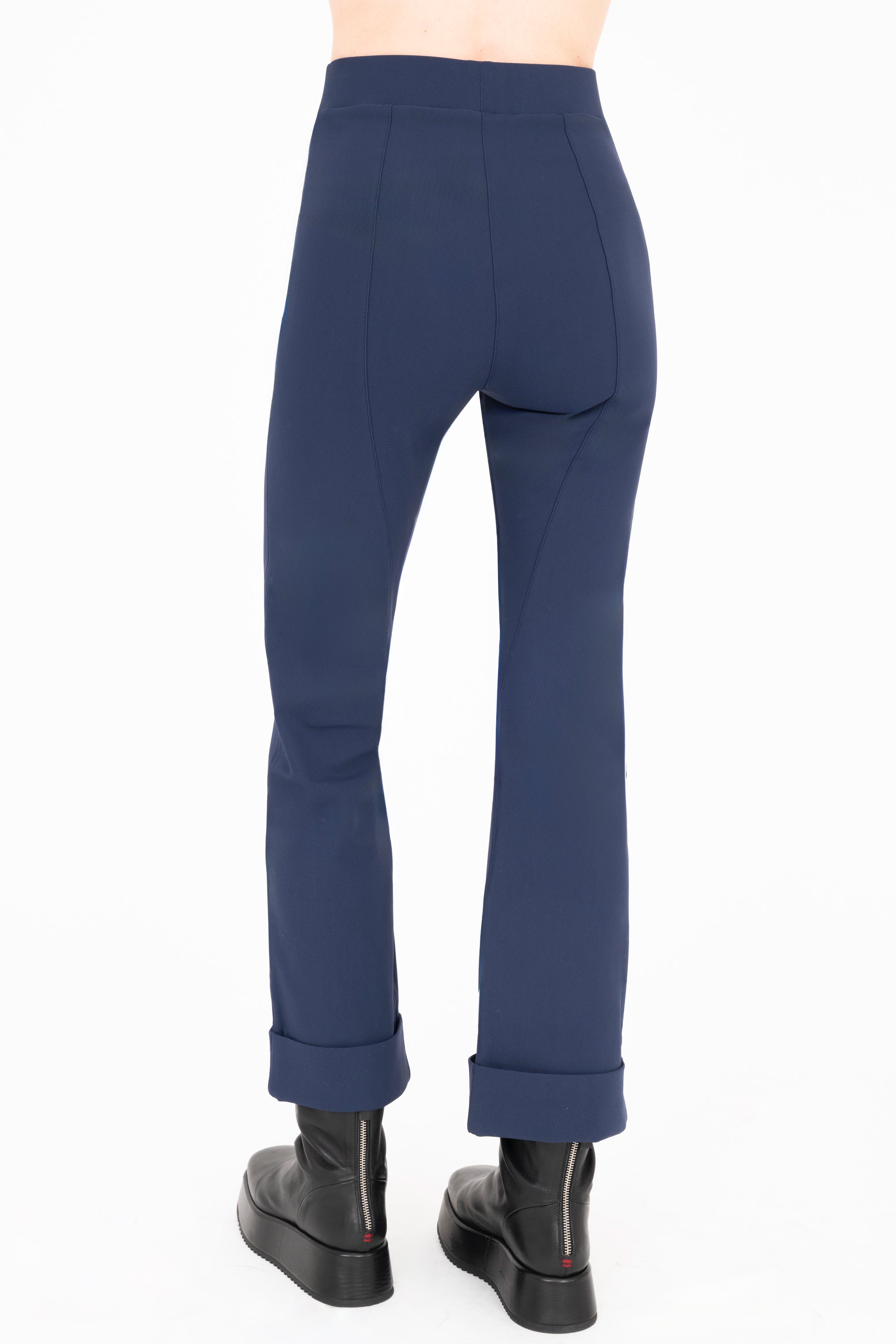 Navy blue pants worn by a person on a white background