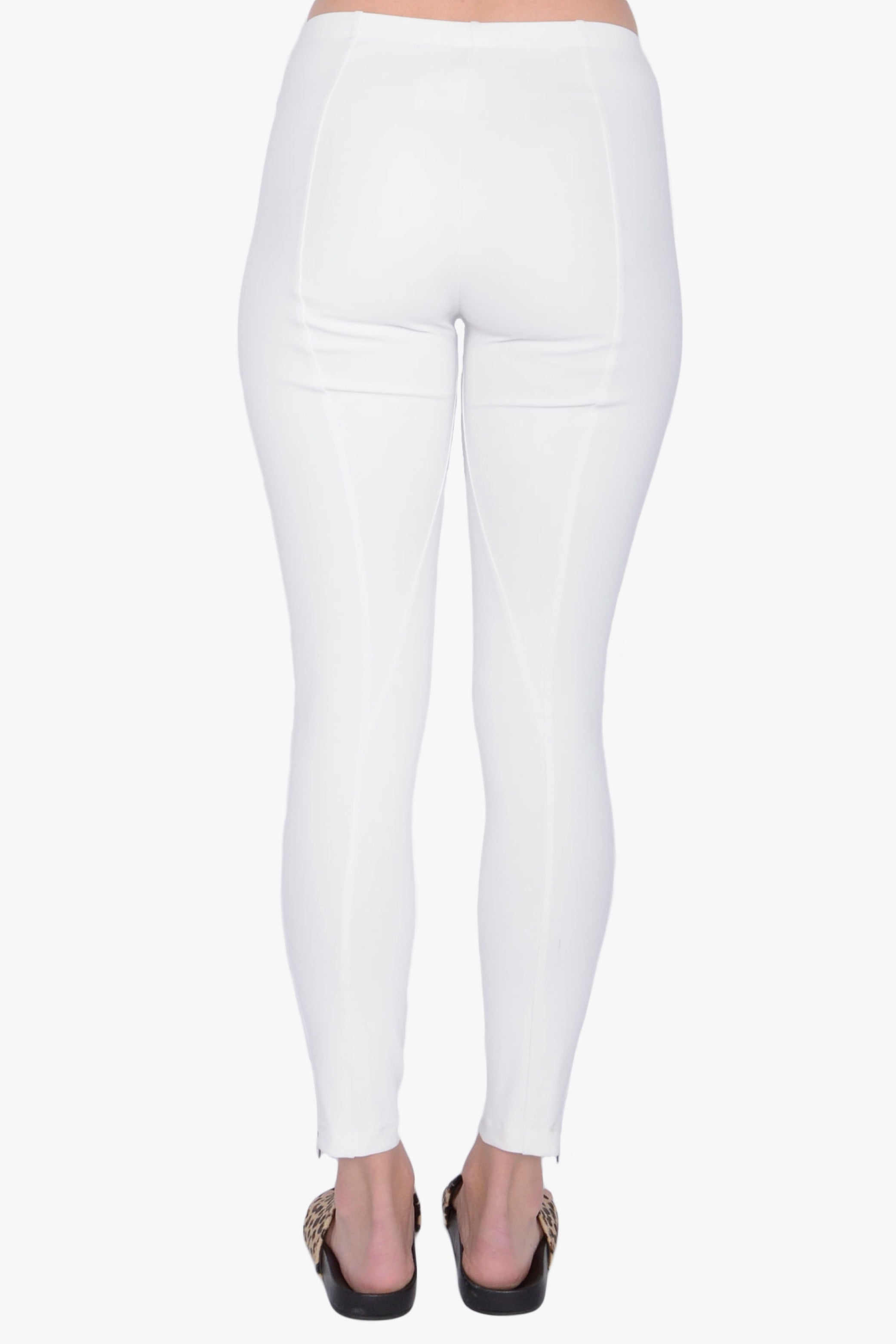 White leggings worn by a person on a white background