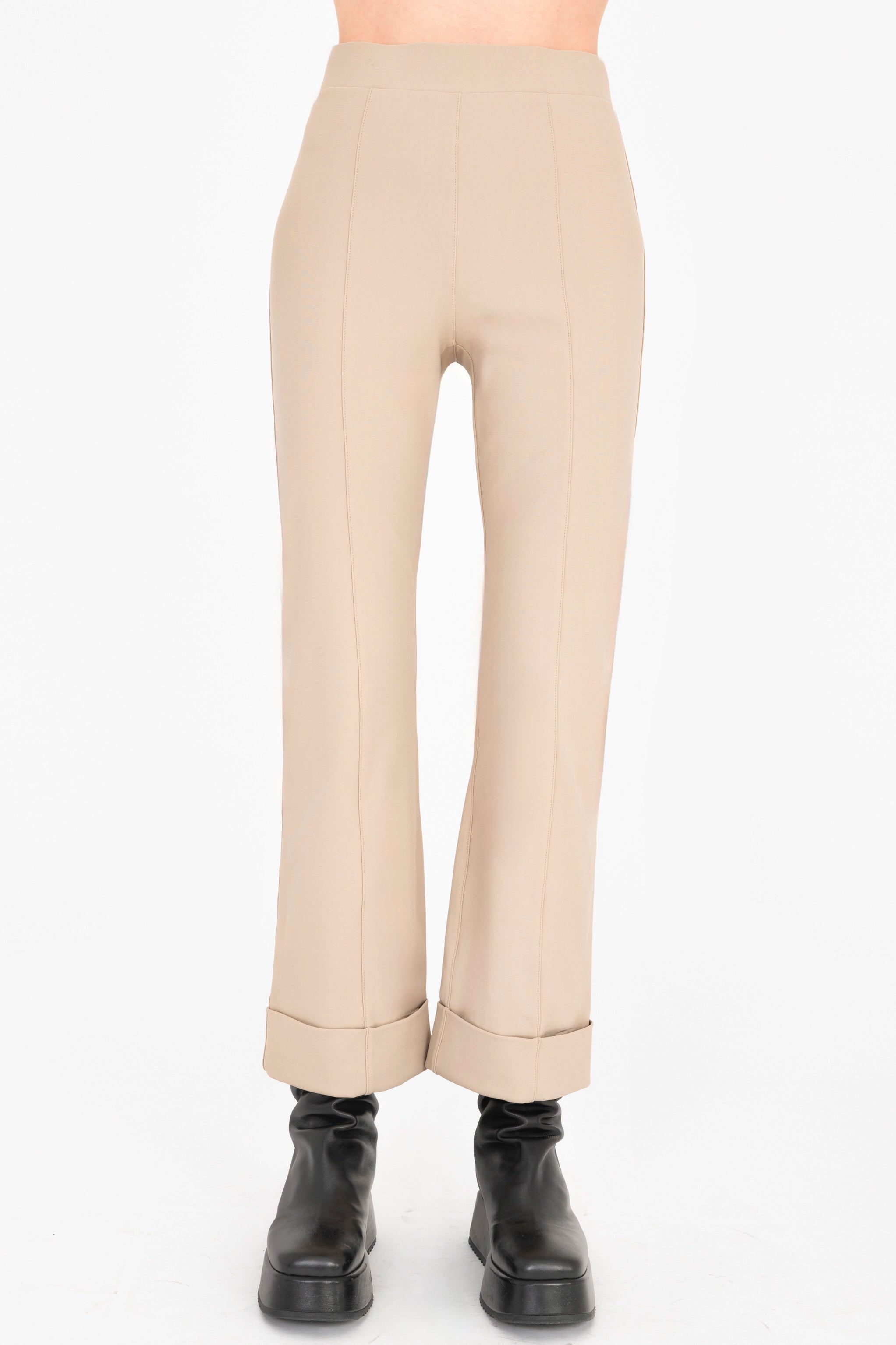Beige pants worn by a person on a white background