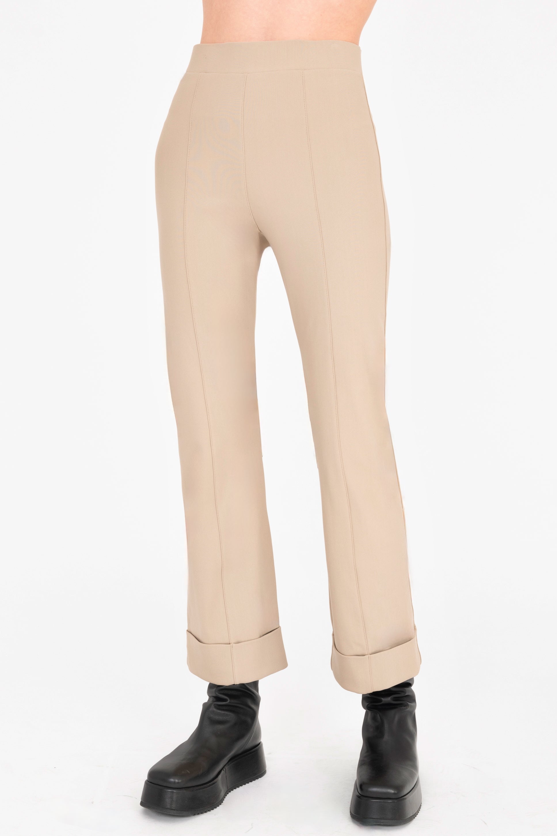 Beige pants worn by a person on a white background