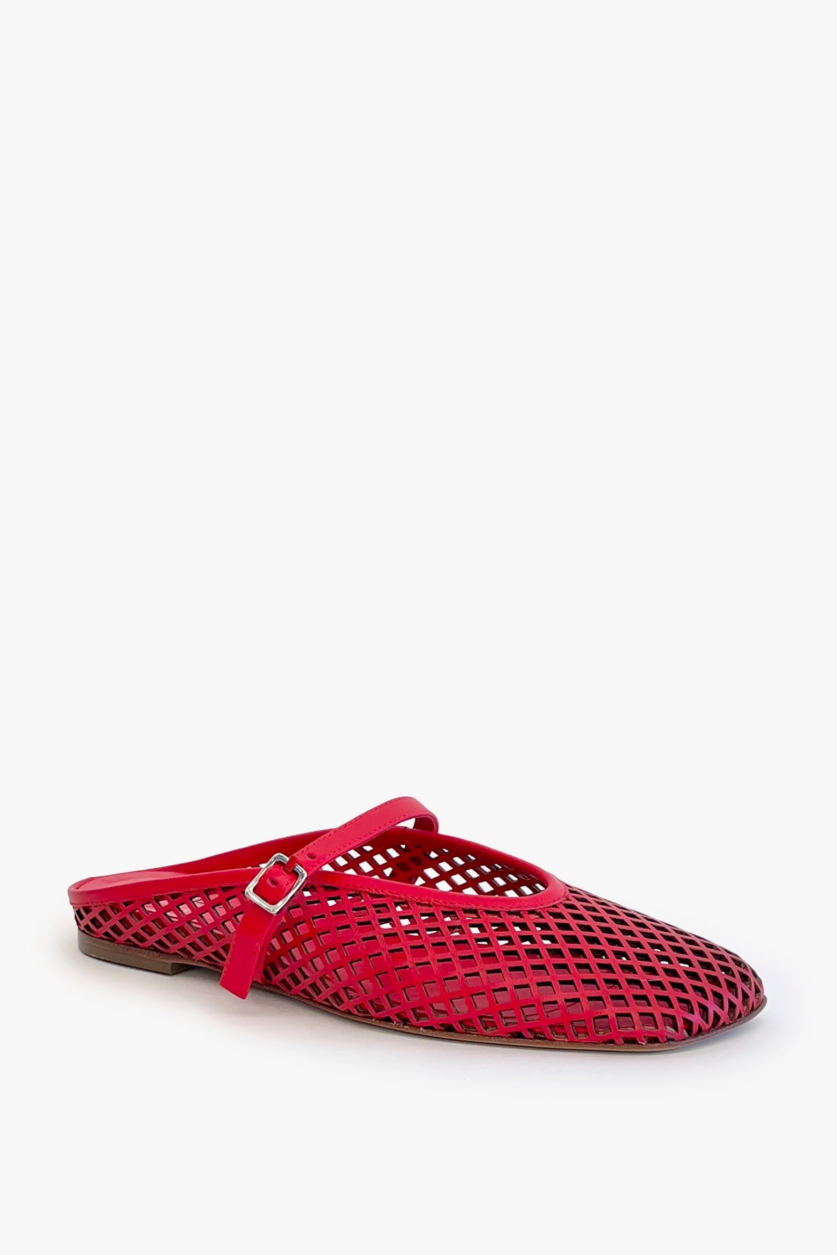 Red laser cut leather strap slip on flat shoe on a white background