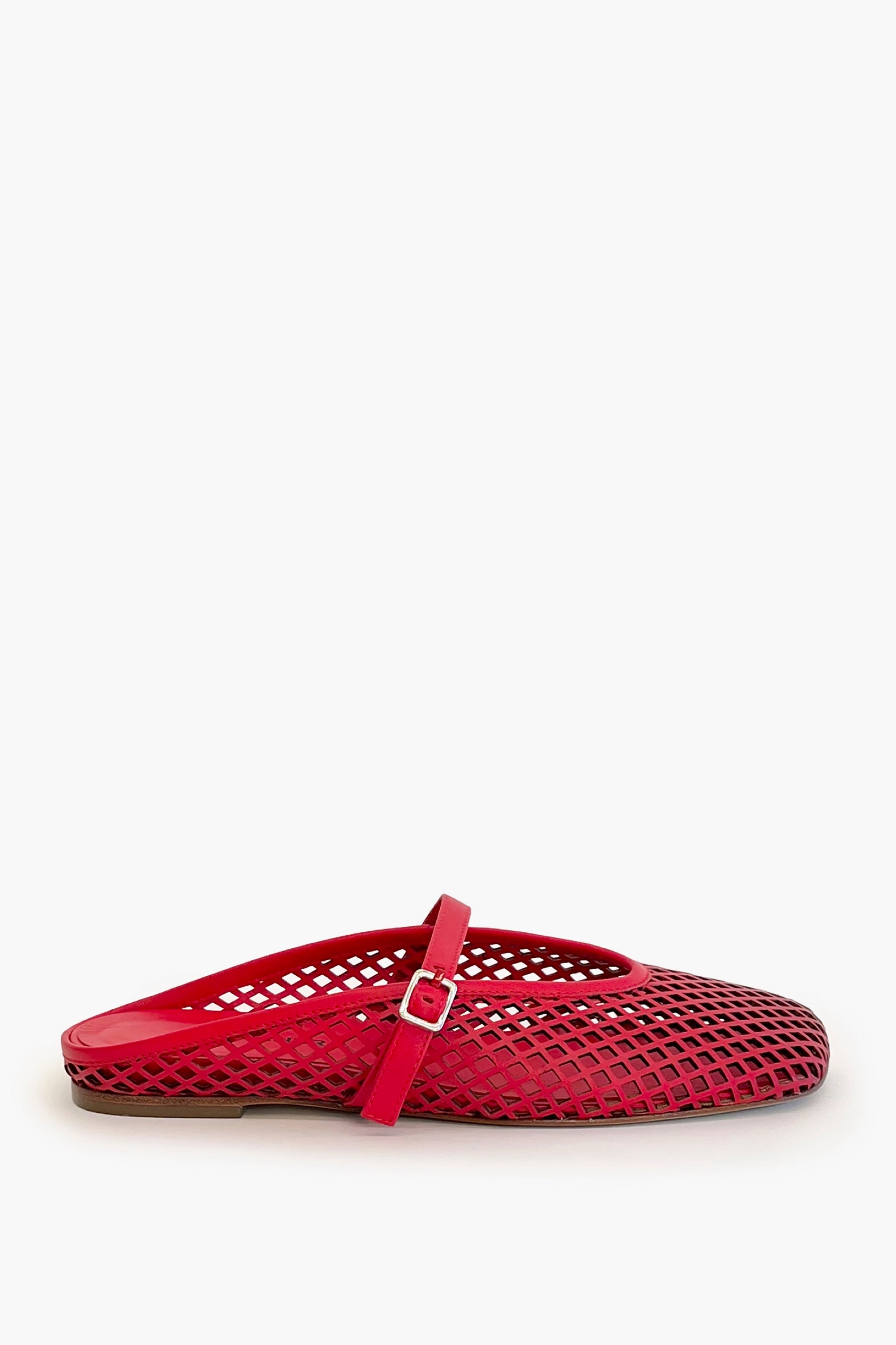 Red laser cut leather strap slip on flat shoe on a white background