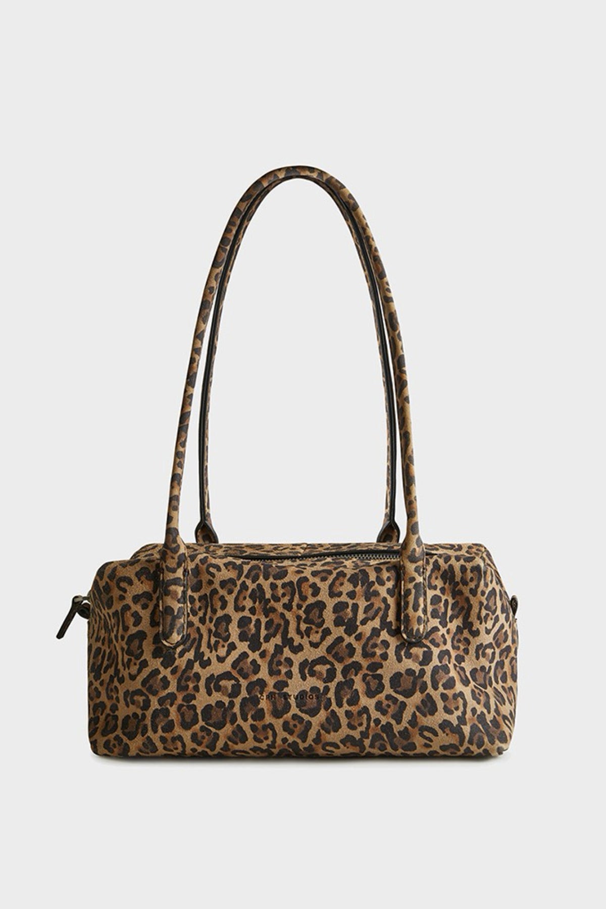 A leopard print suede bag with two shoulder straps, shown against a plain light gray background.