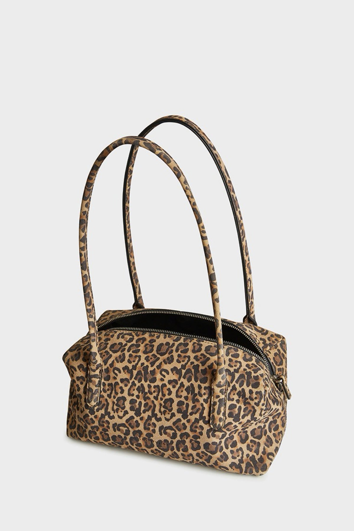 A leopard print suede bag with two shoulder straps, shown against a plain light gray background.