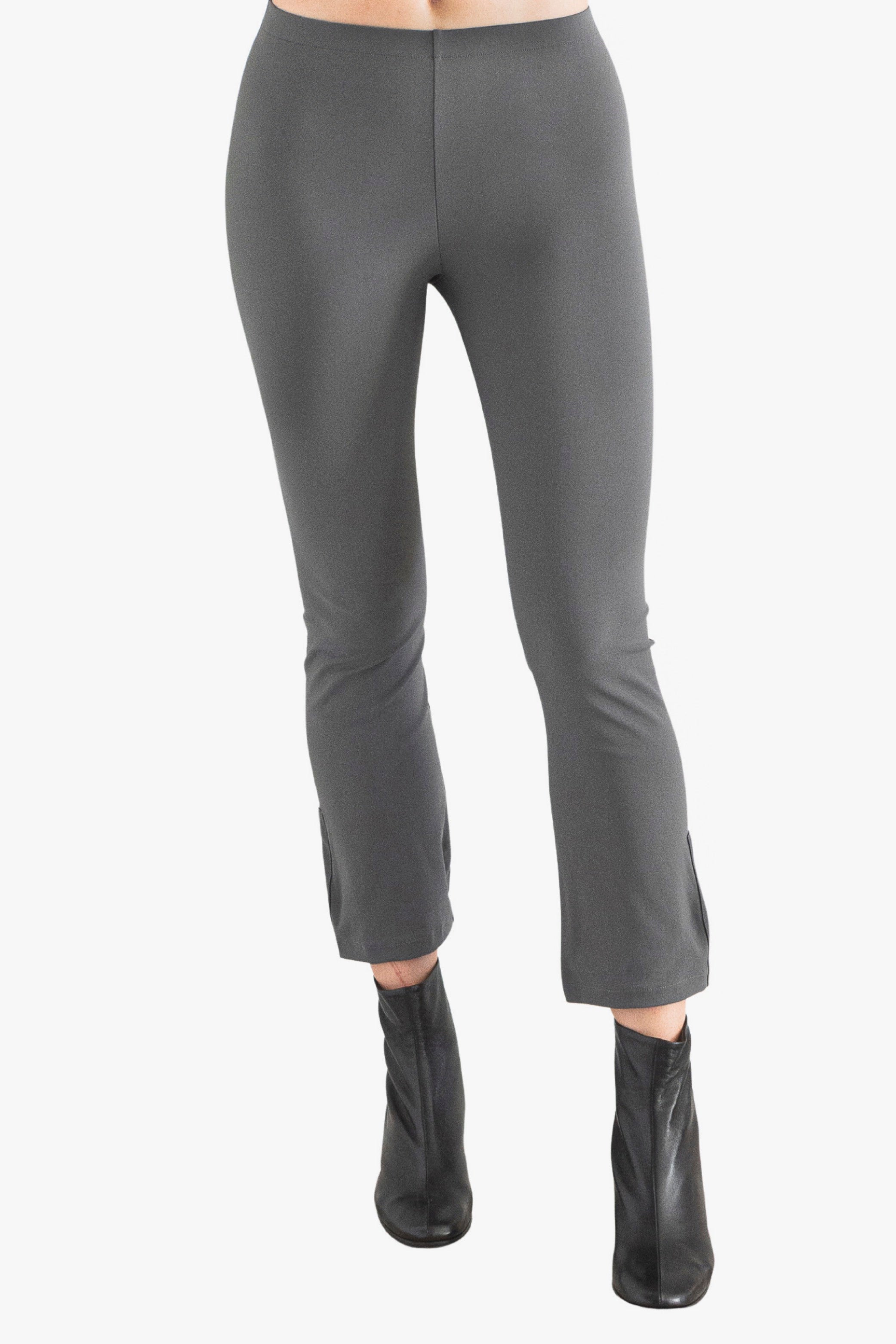 Gray pants worn by a person on a white background