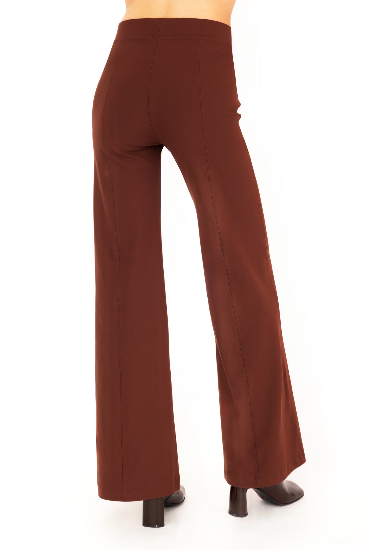 A model wearing high-waisted, wide-leg brown pants with dark brown boots, shown from the waist down against a plain white background.