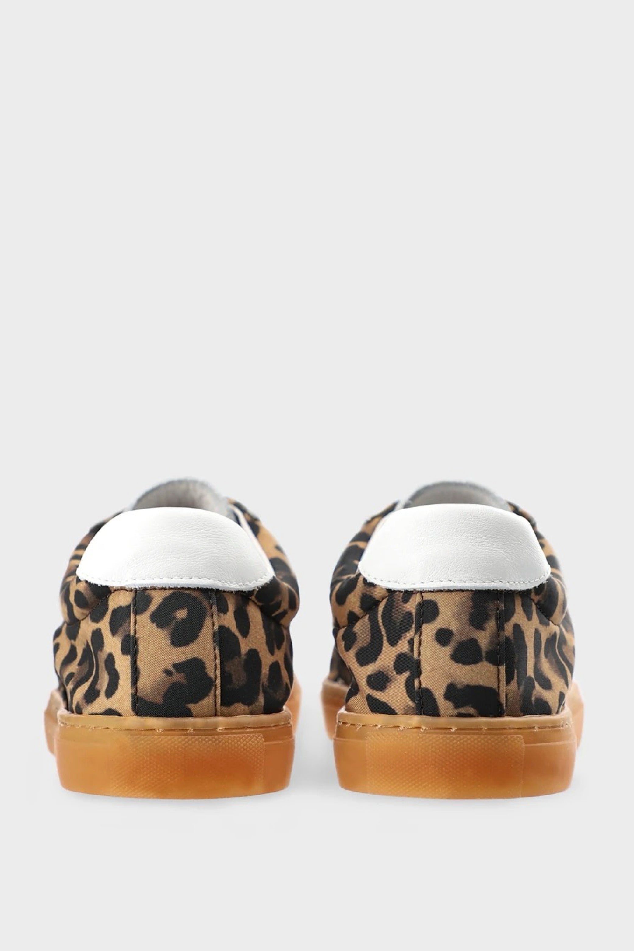 Leopard print sneaker with white laces on a light gray background