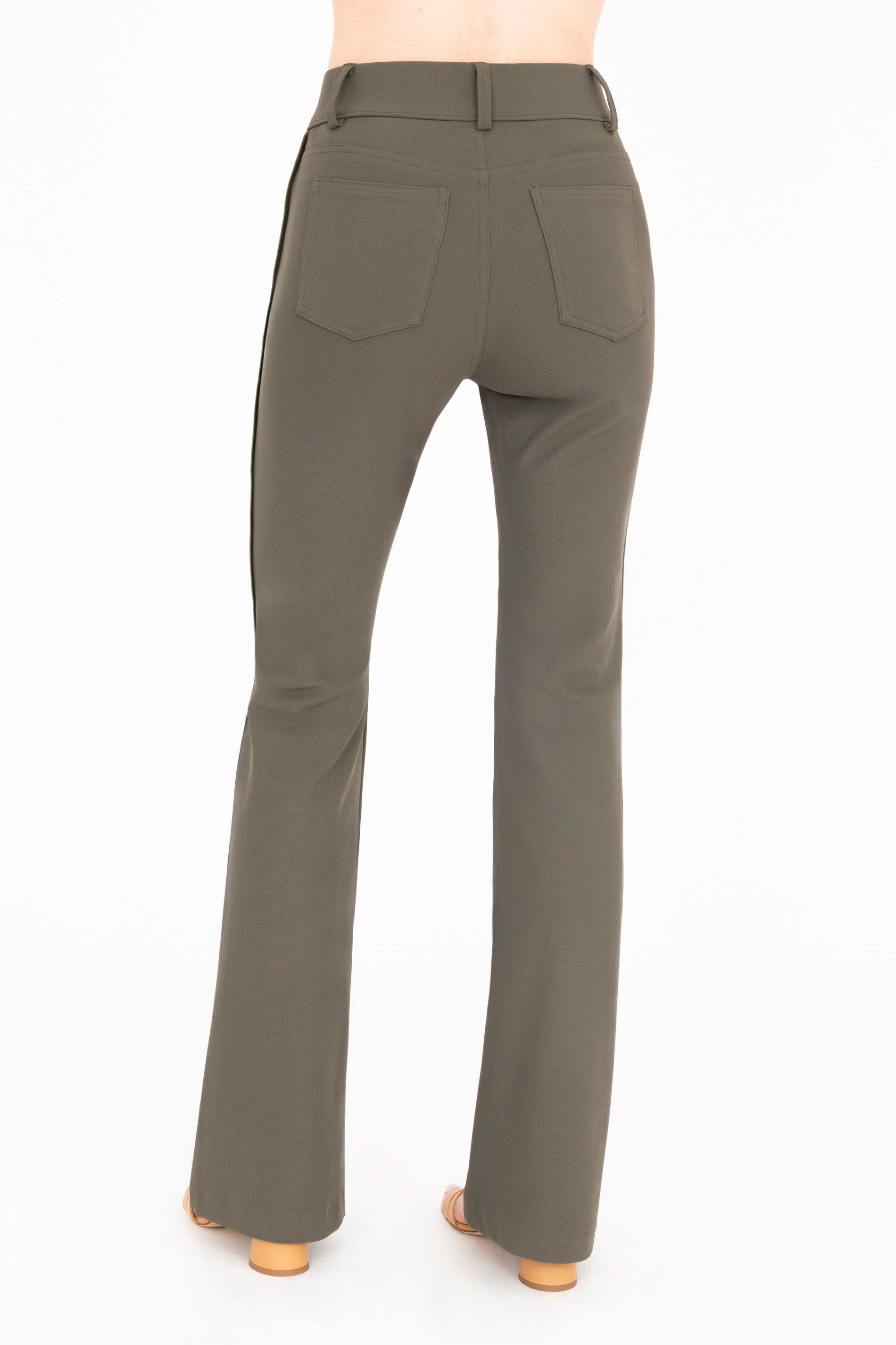 Back view of olive flare jean pants on a white background