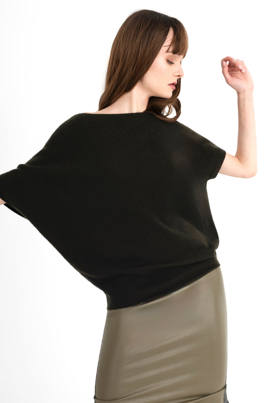 Woman wearing a green top and green skirt on a white background