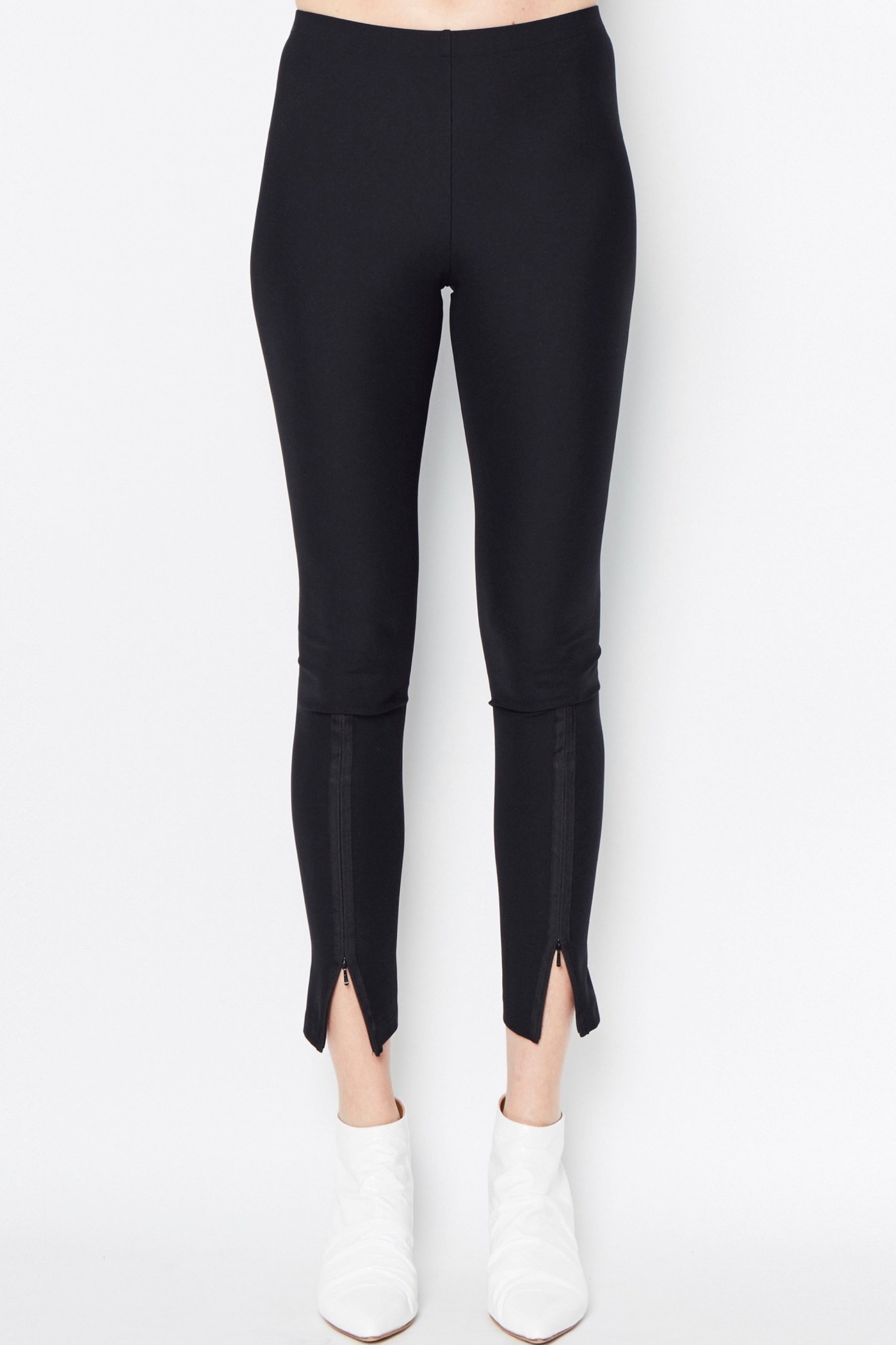 Black leggings with front slits on a white background