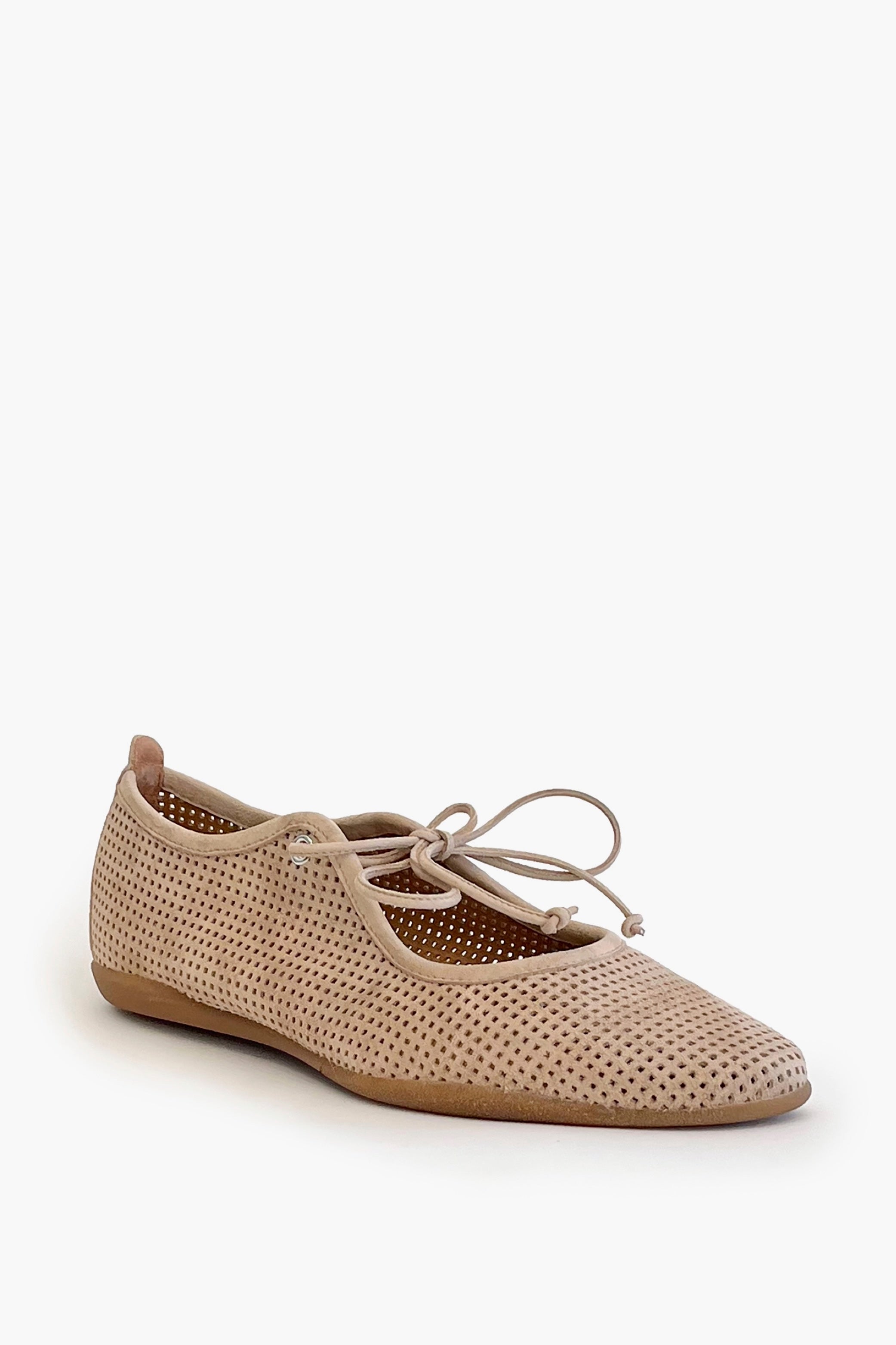 Beige perforated suede ballet flat shoe on a white background