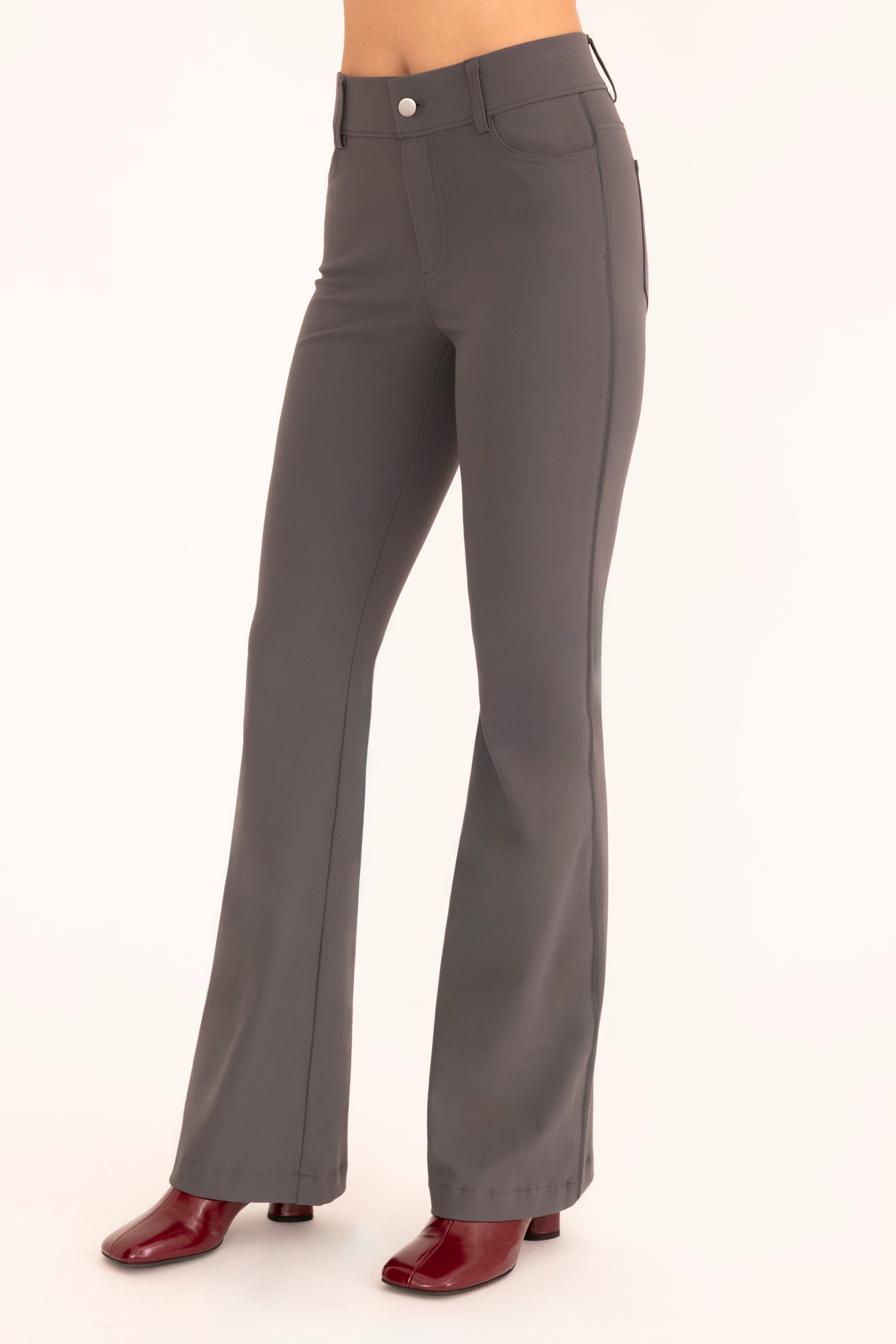 Side view of gray flare jean pants on a white background