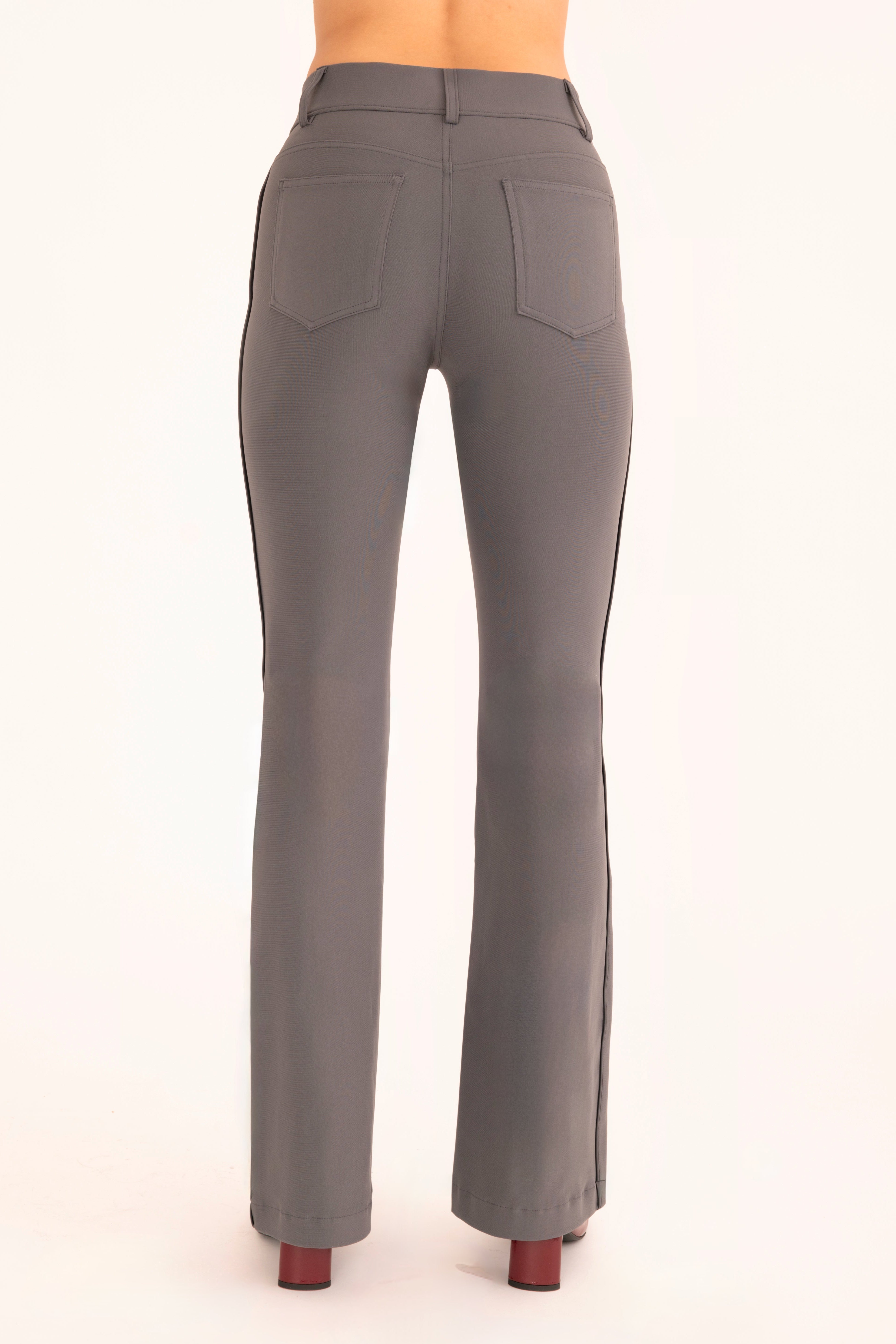 Back view of gray flare jean pants on a white background