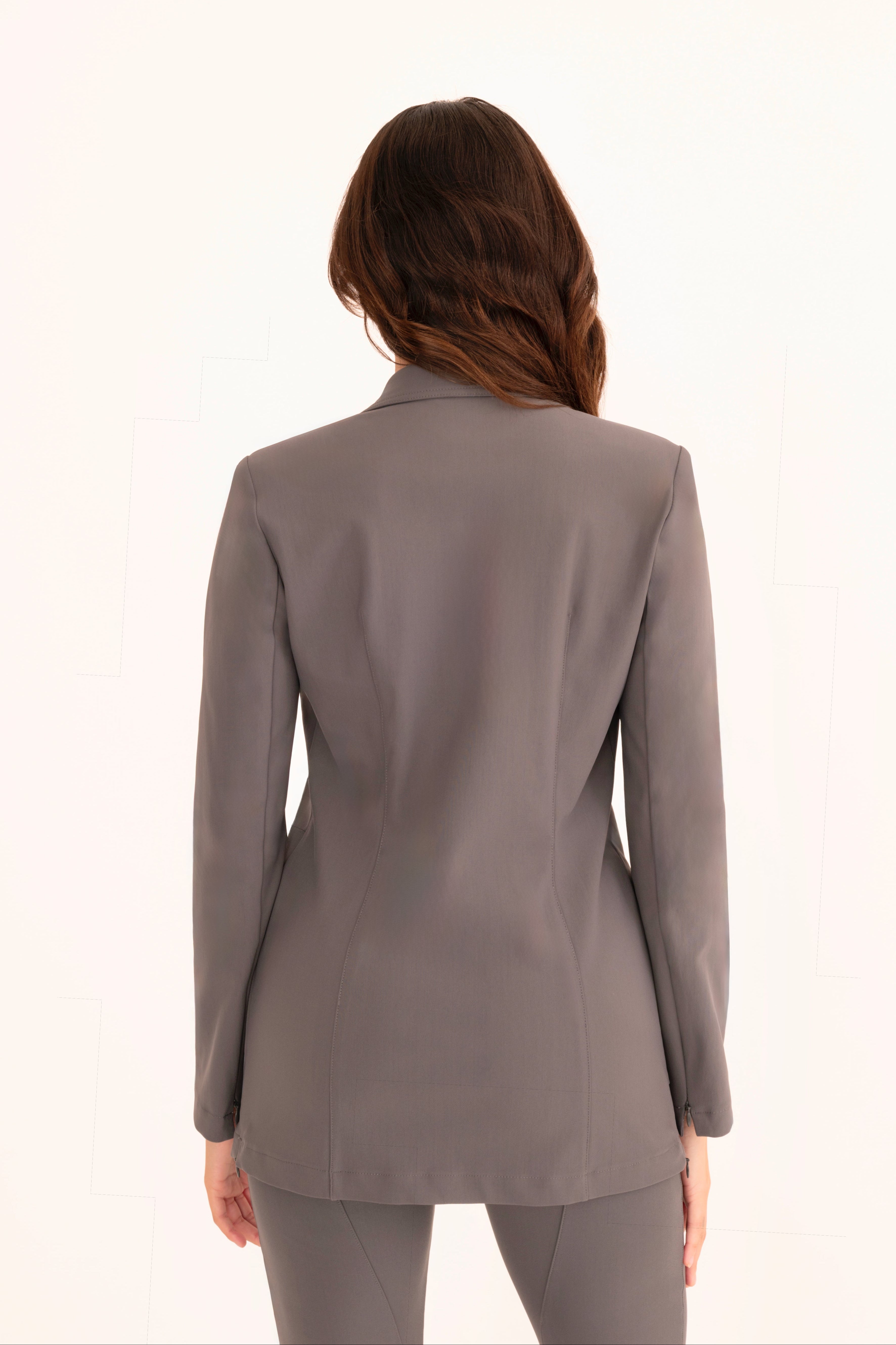 Woman wearing a gray suit on a white background