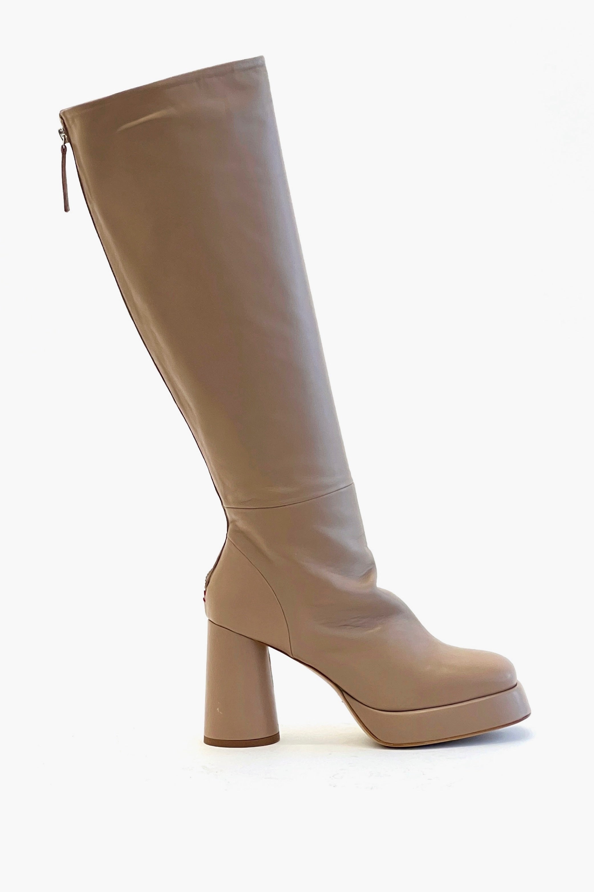 Beige knee-high boot with a platform sole on a white background