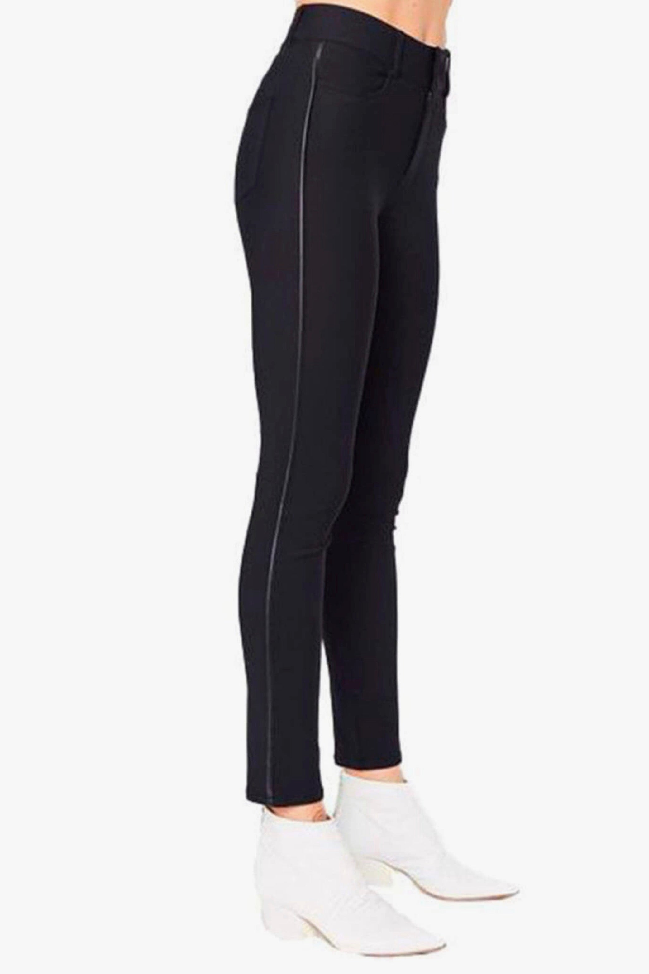 Black pants worn by a person on a white background