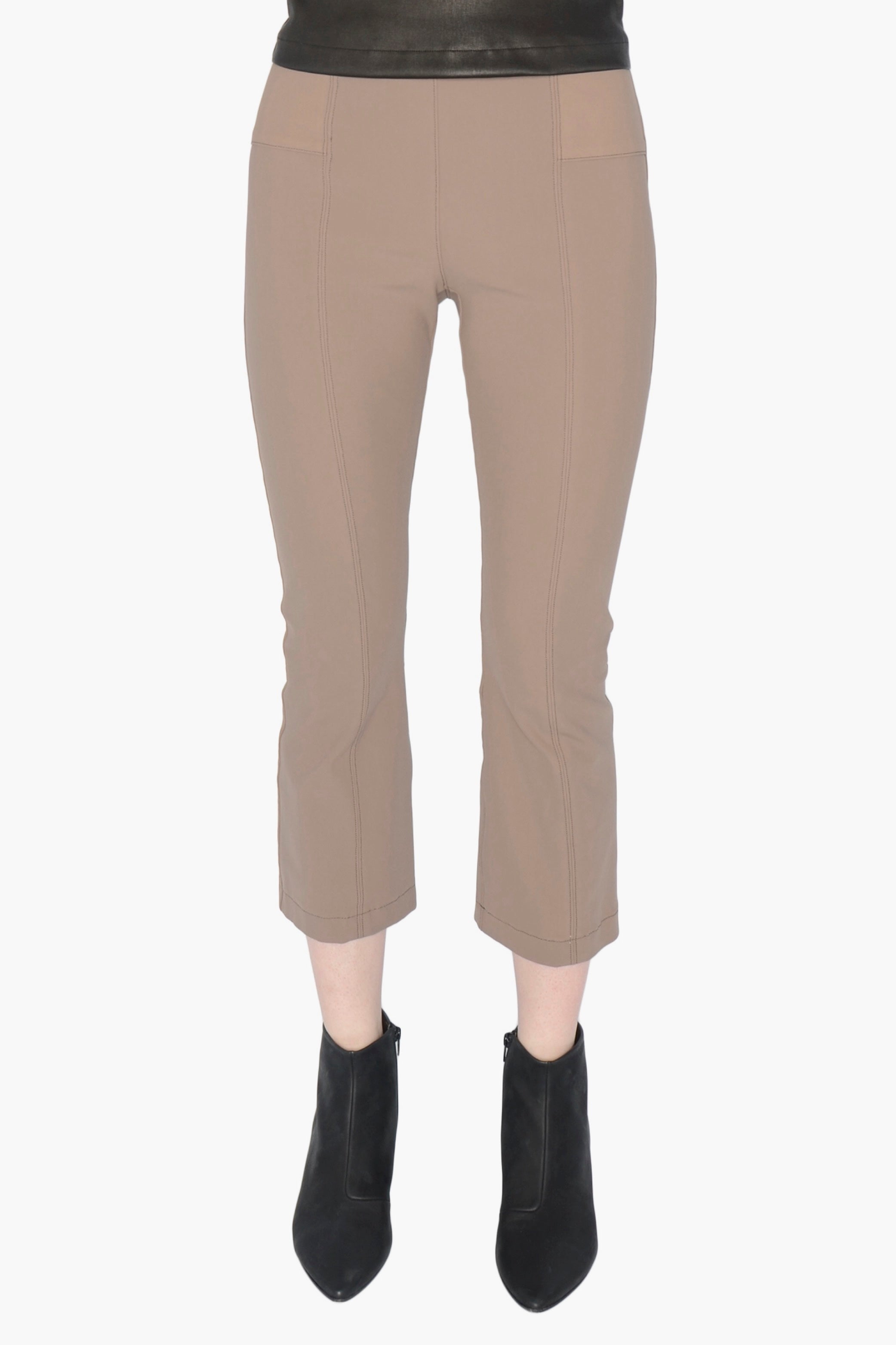 Beige pants worn by a person on a white background
