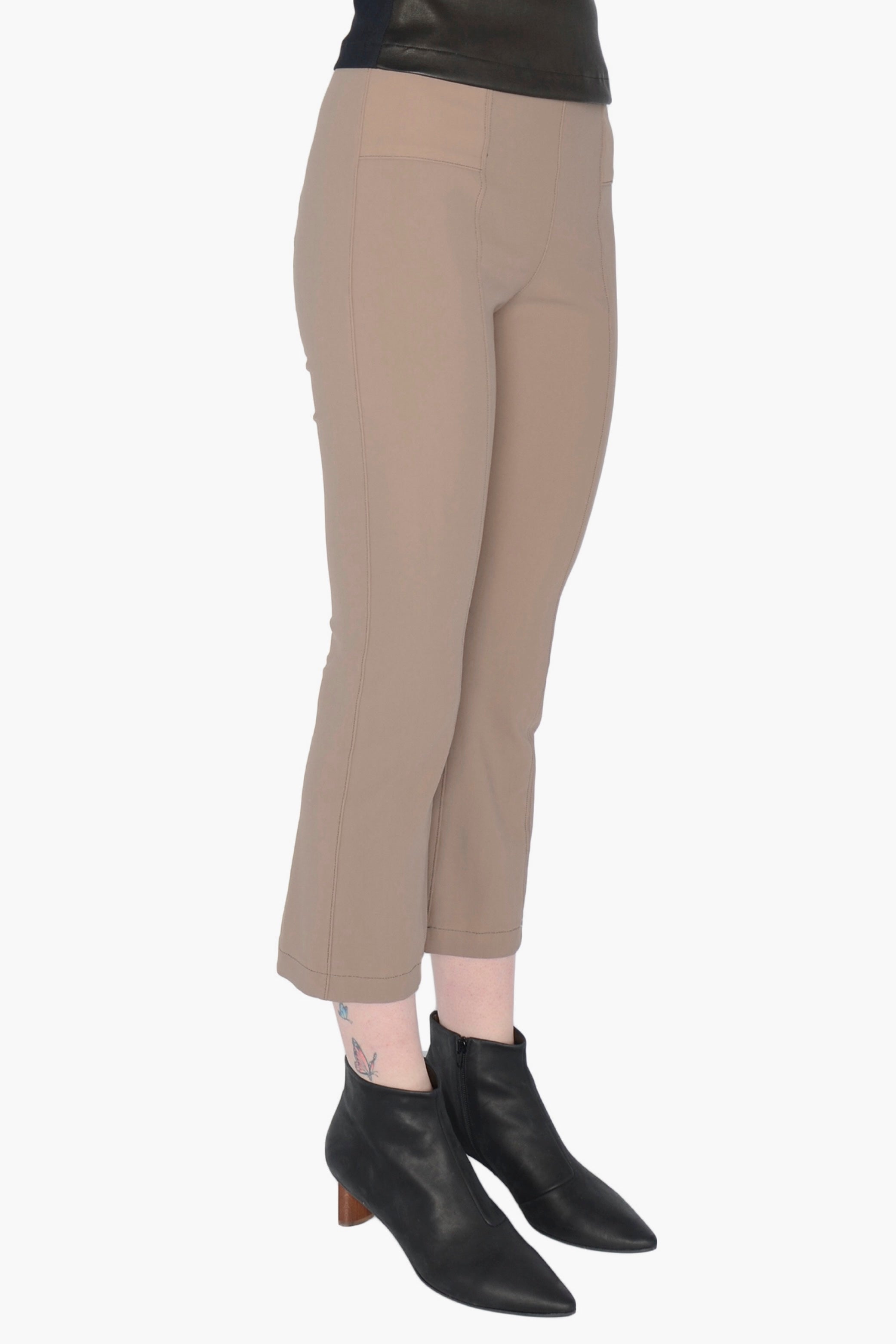 Beige pants worn by a person on a white background