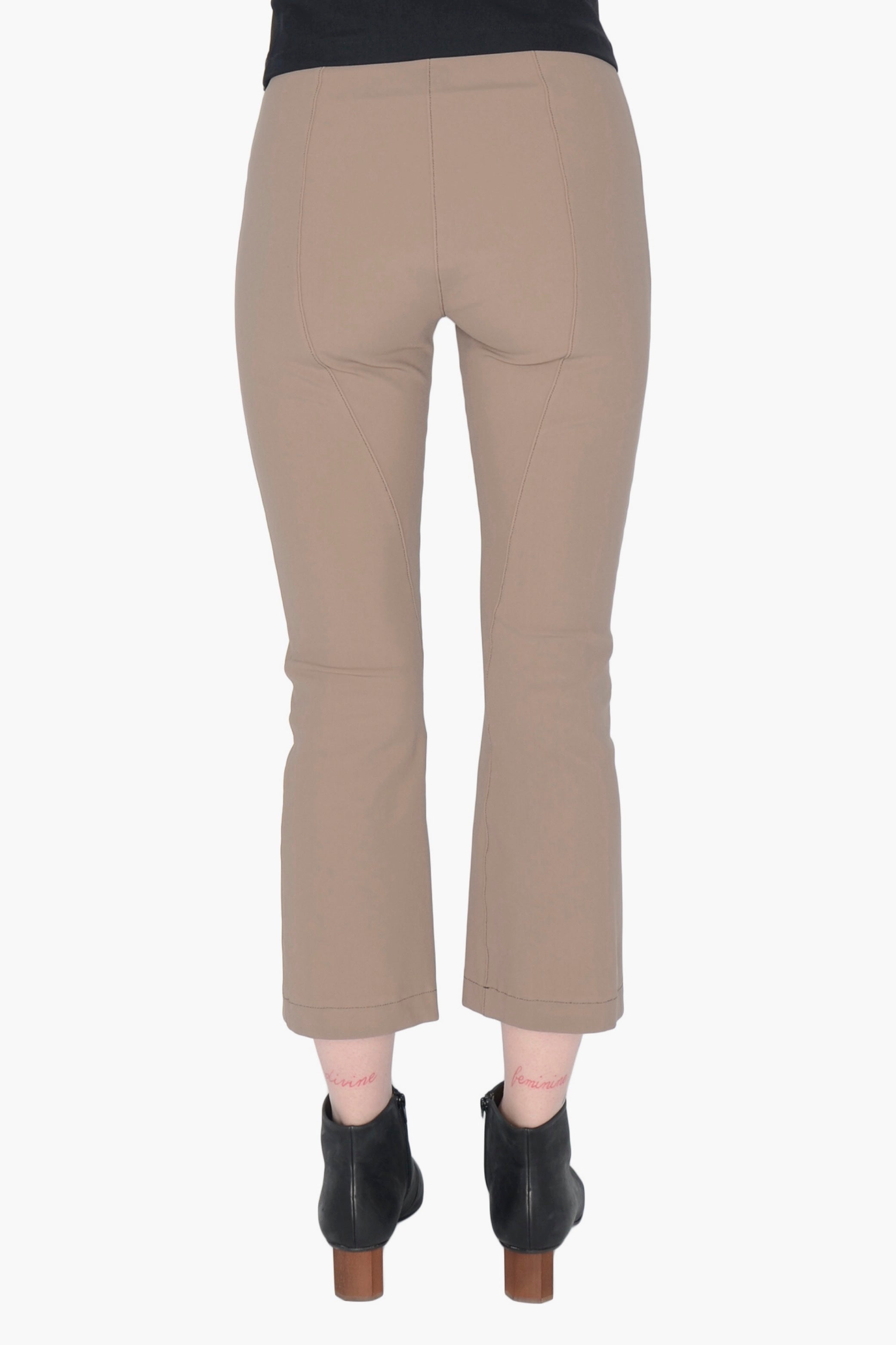 Beige pants worn by a person on a white background