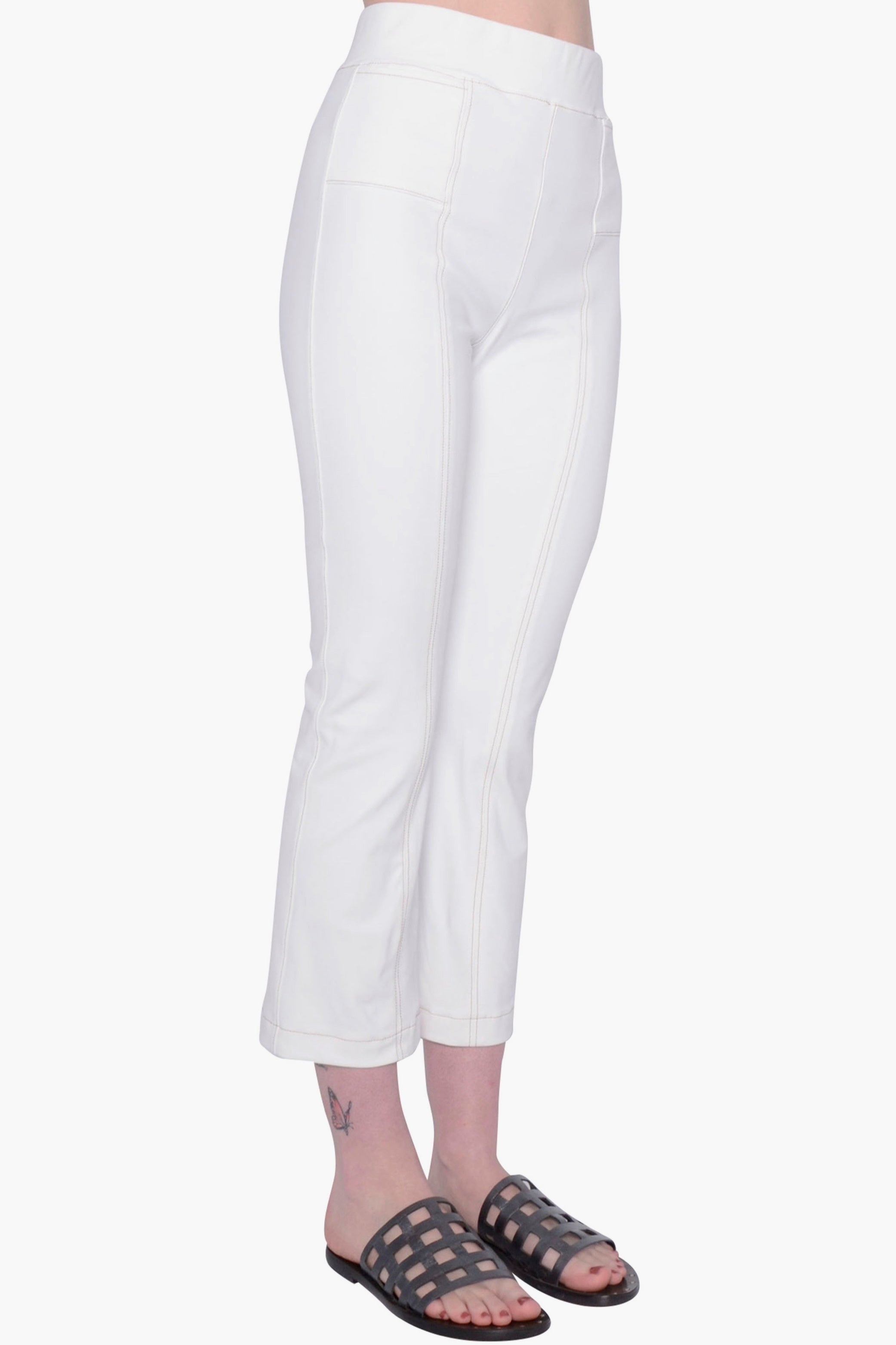 White pants worn by a person on a white background