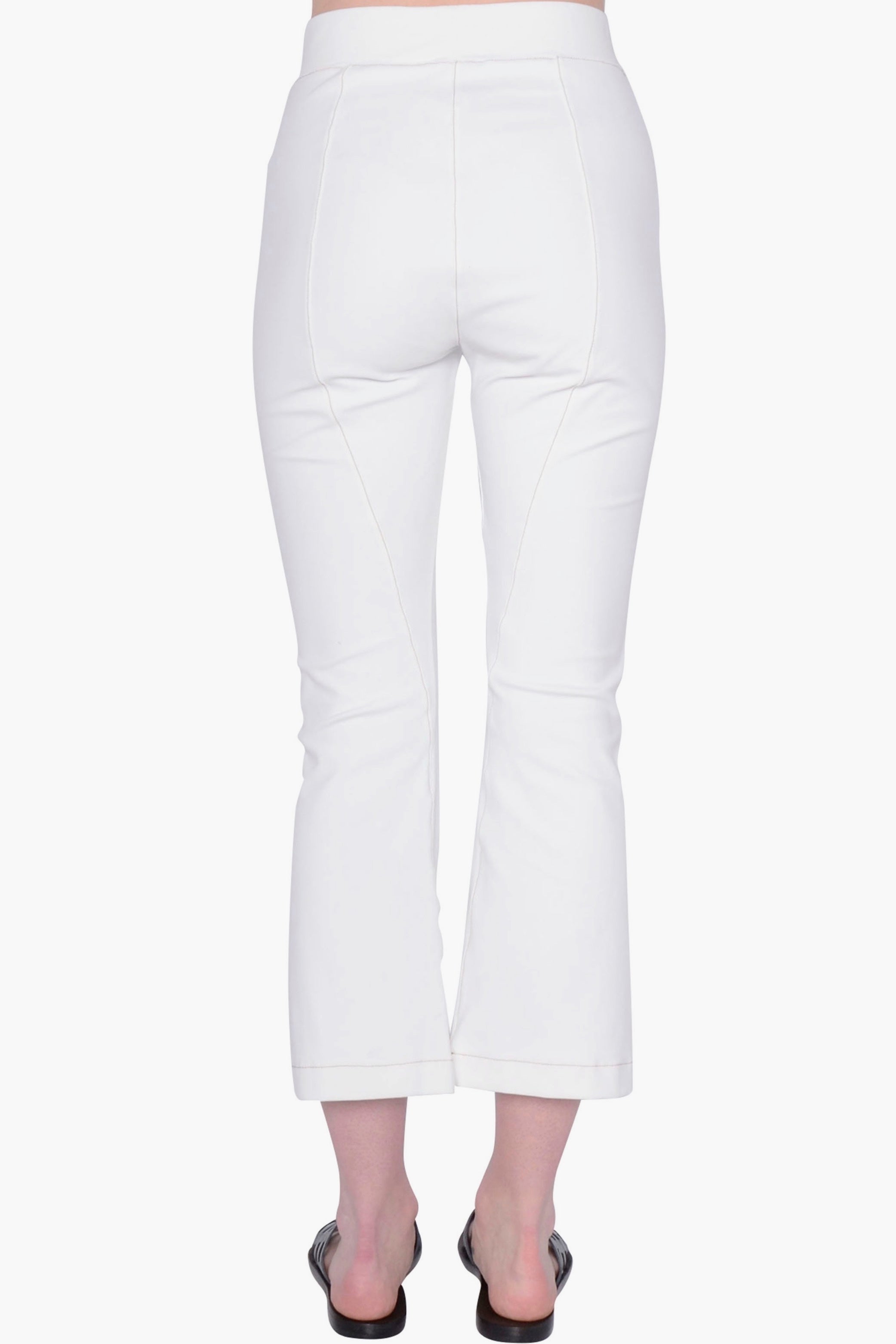 White pants worn by a person on a white background