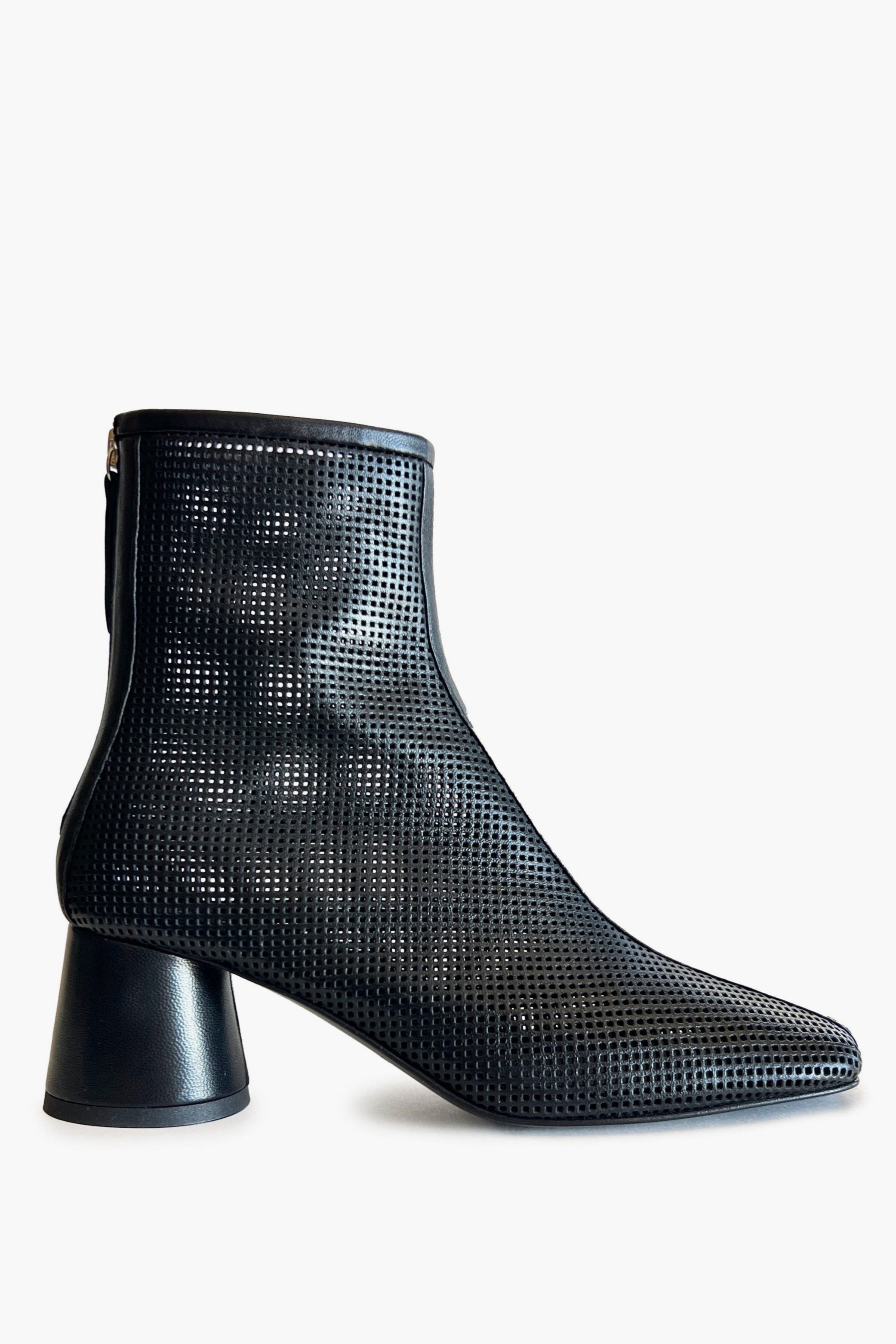 Black round toe perforated ankle boot on a white background