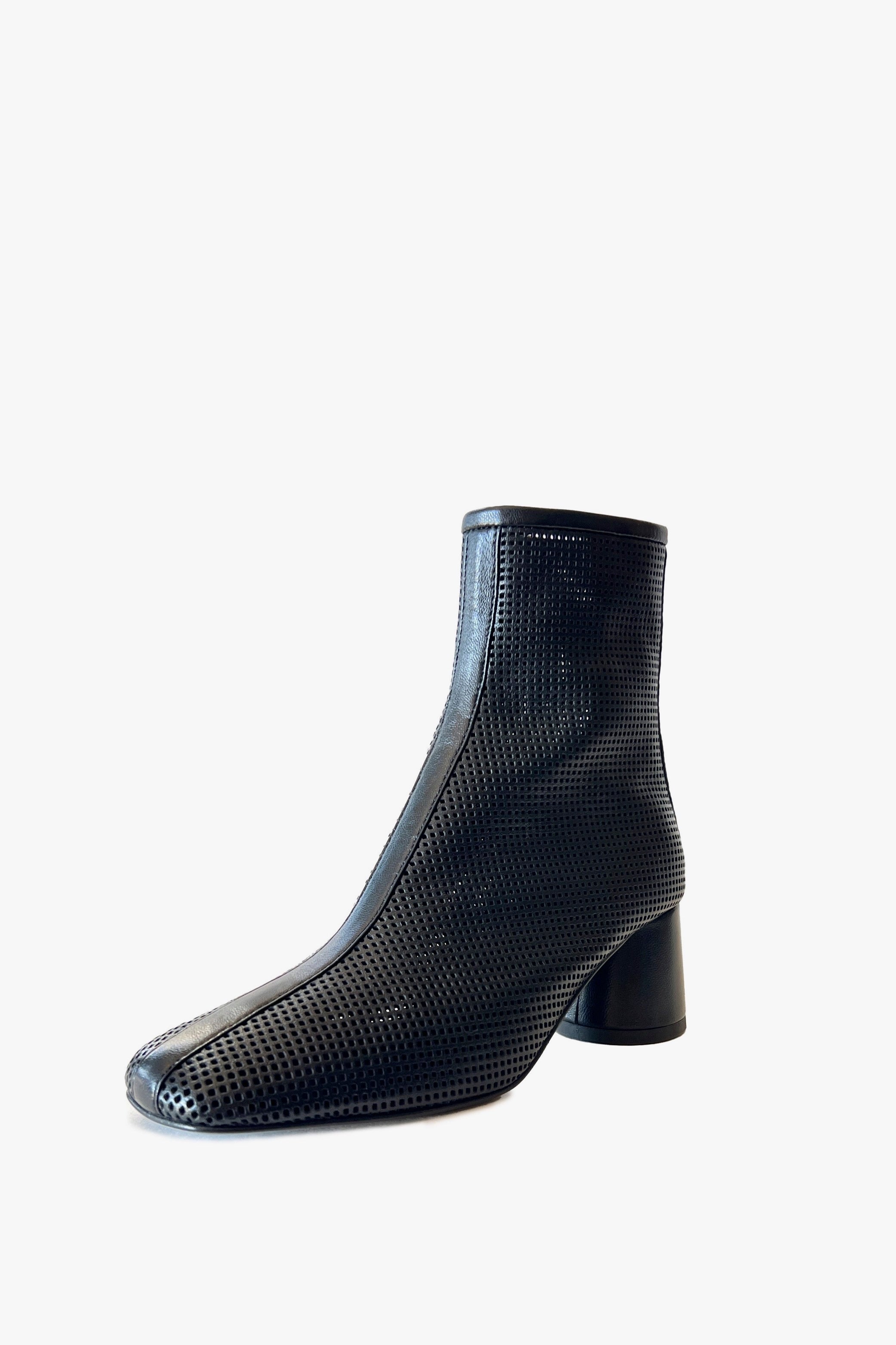 Black round toe perforated ankle boot on a white background