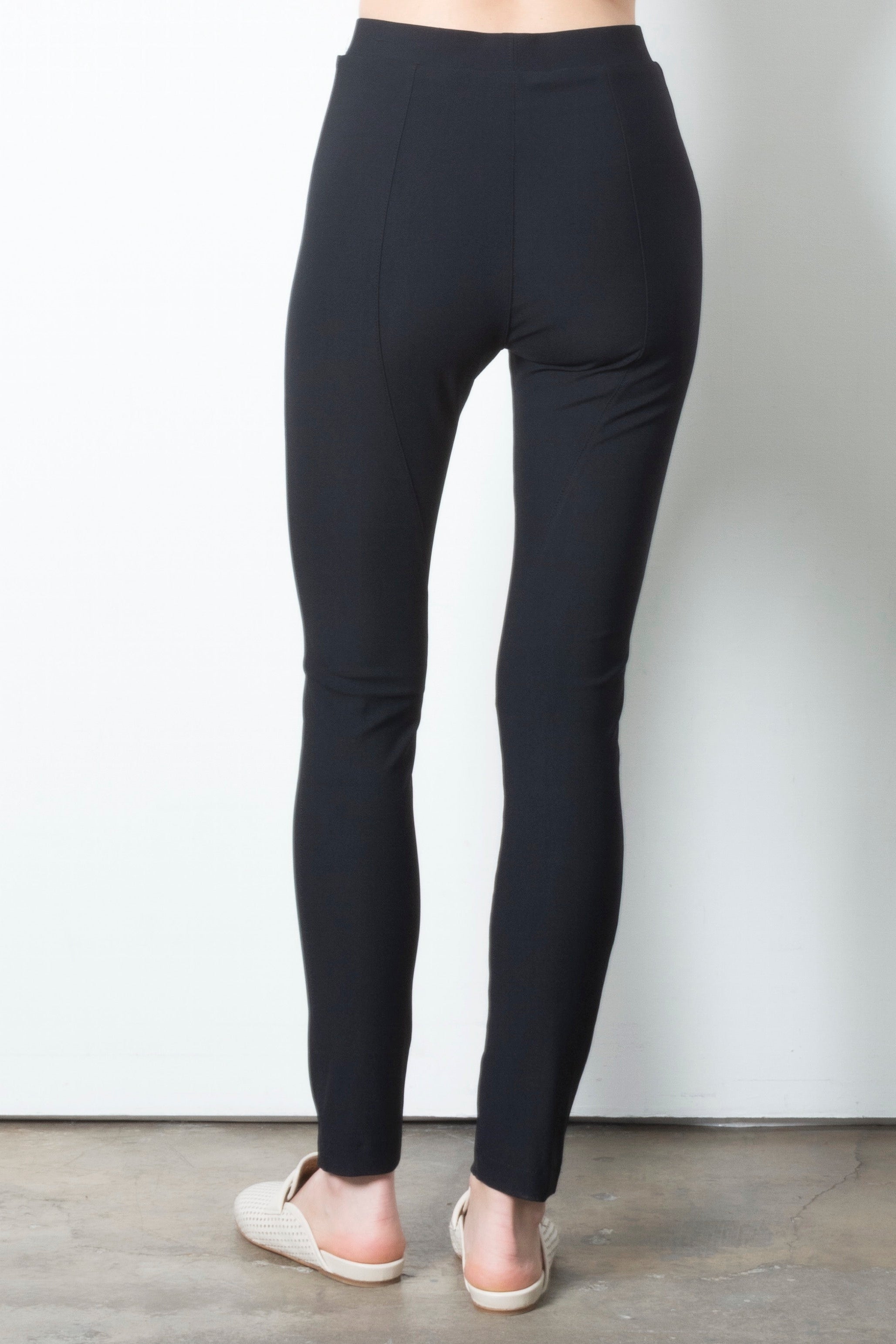 Black leggings worn by a person on a plain background